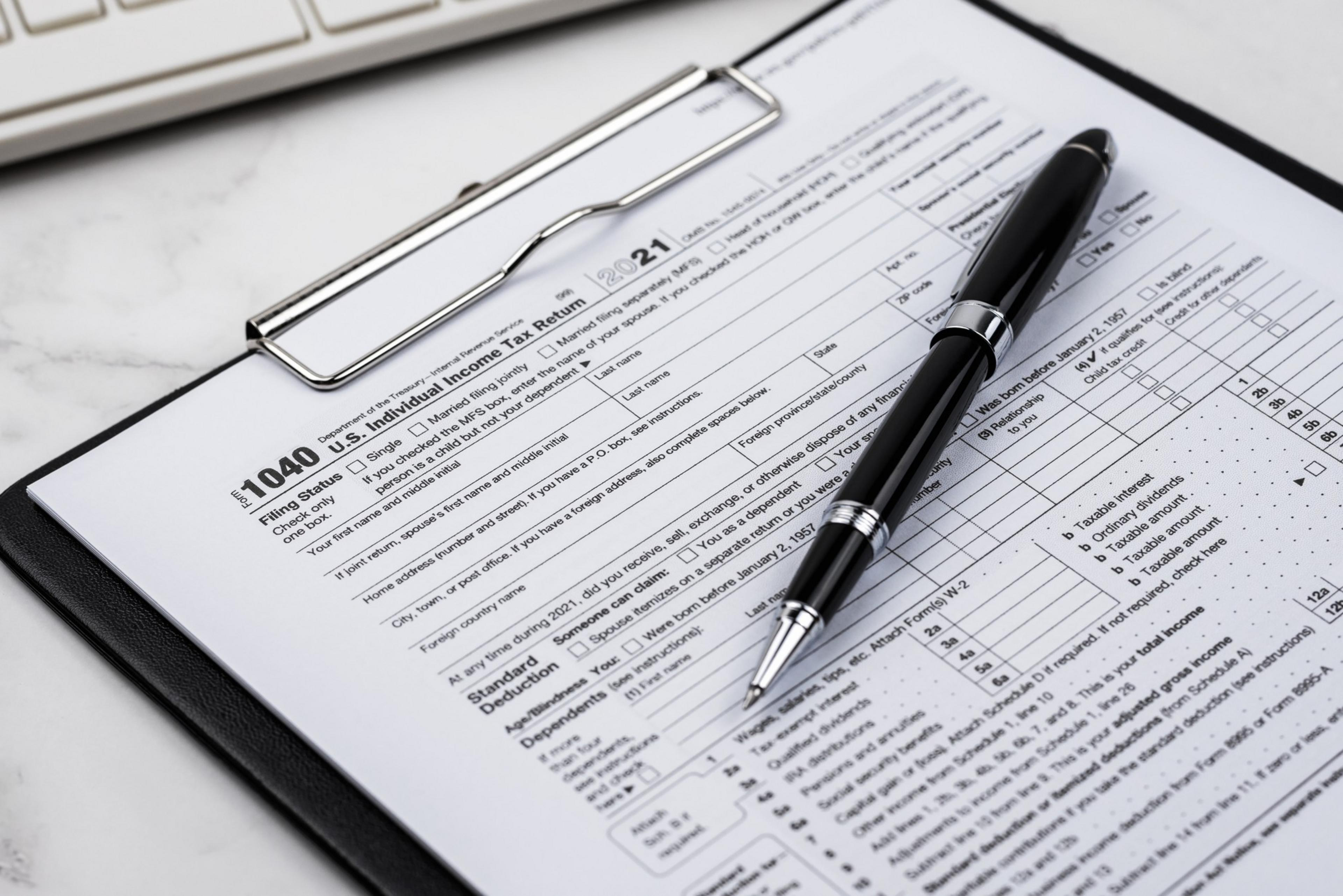 A photo shows a close-up of a Form 1040 tax form.