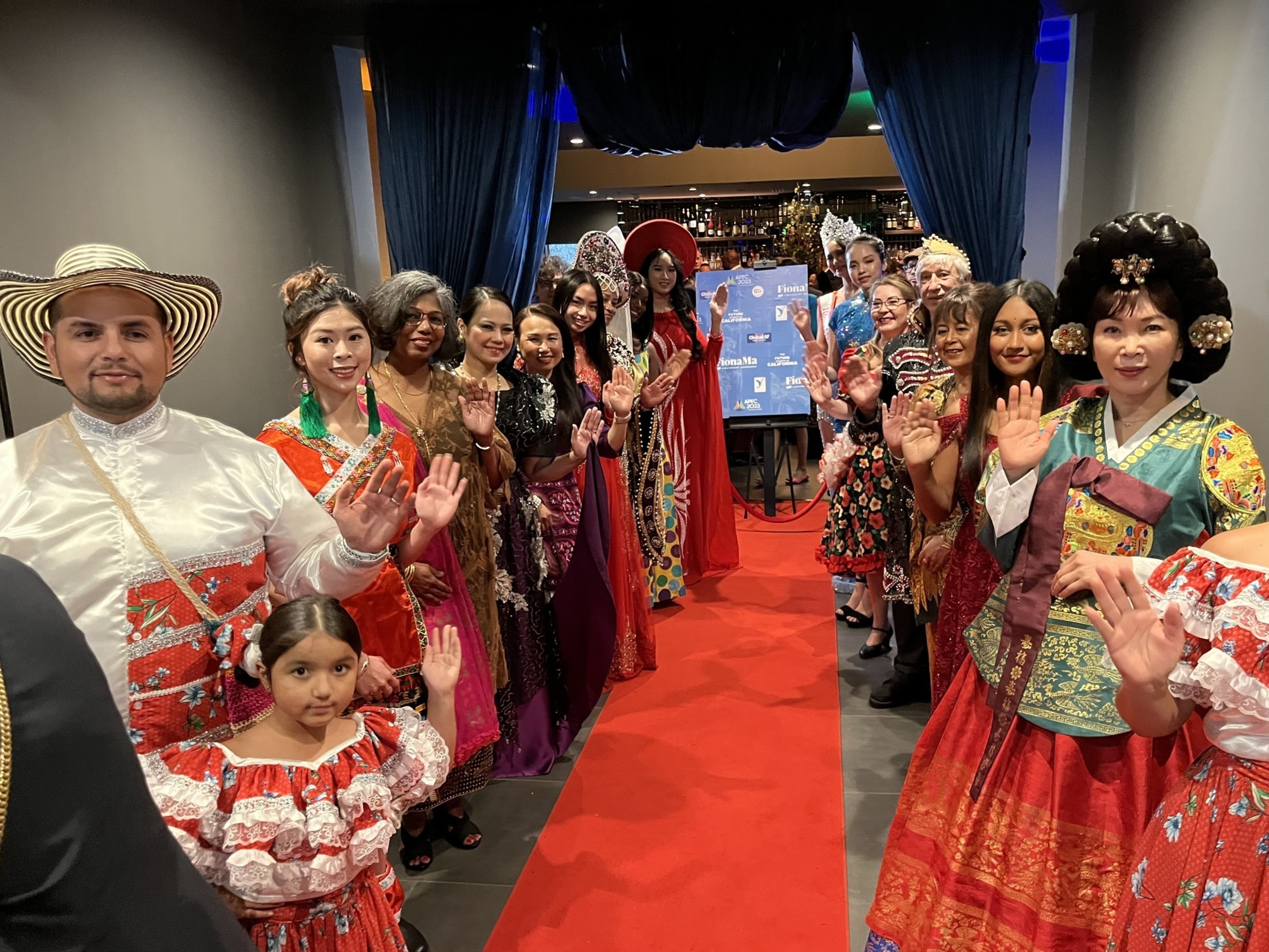 People in different ethnic outfit are standing and welcoming the guests.