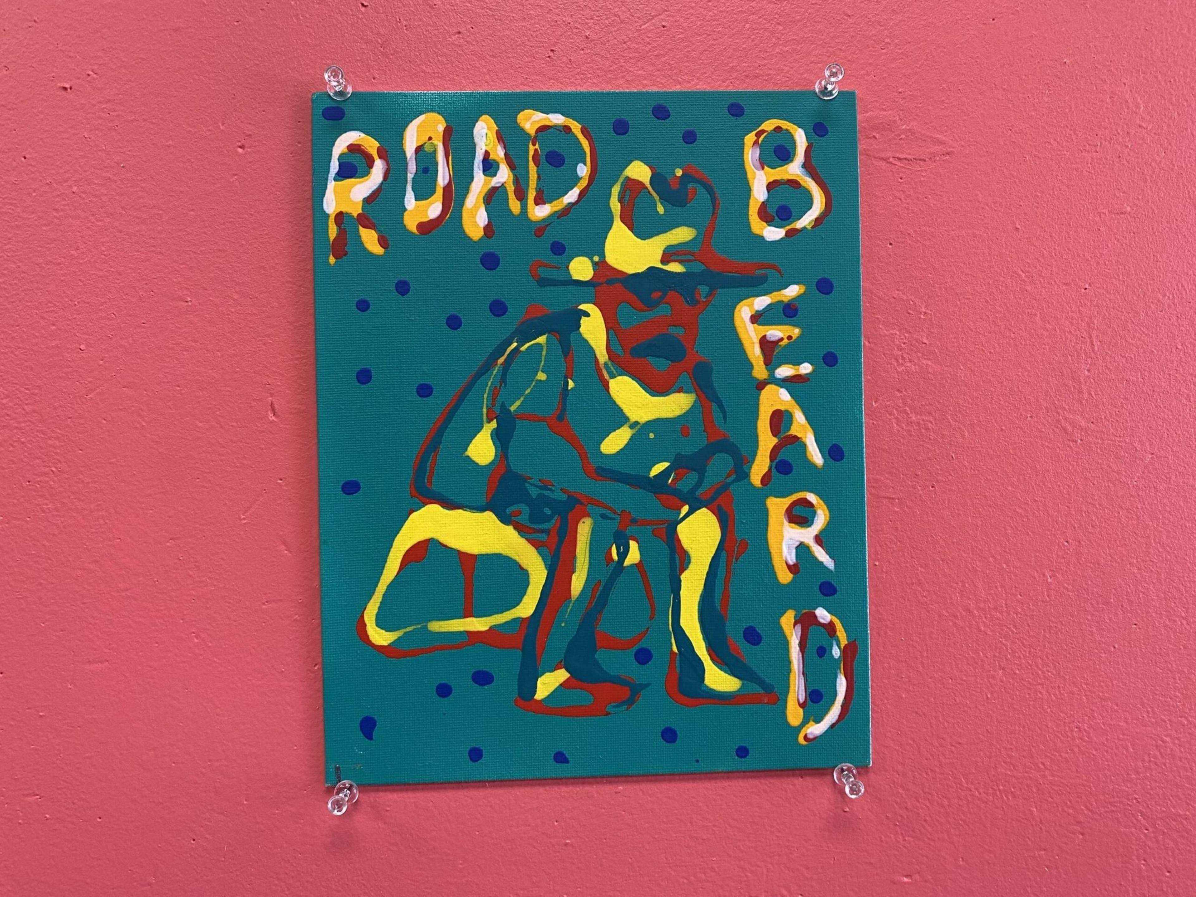 A colorful painting on a teal background with blue dots shows a crouching figure wearing a hat, surrounded by the text "ROAD BEARD."