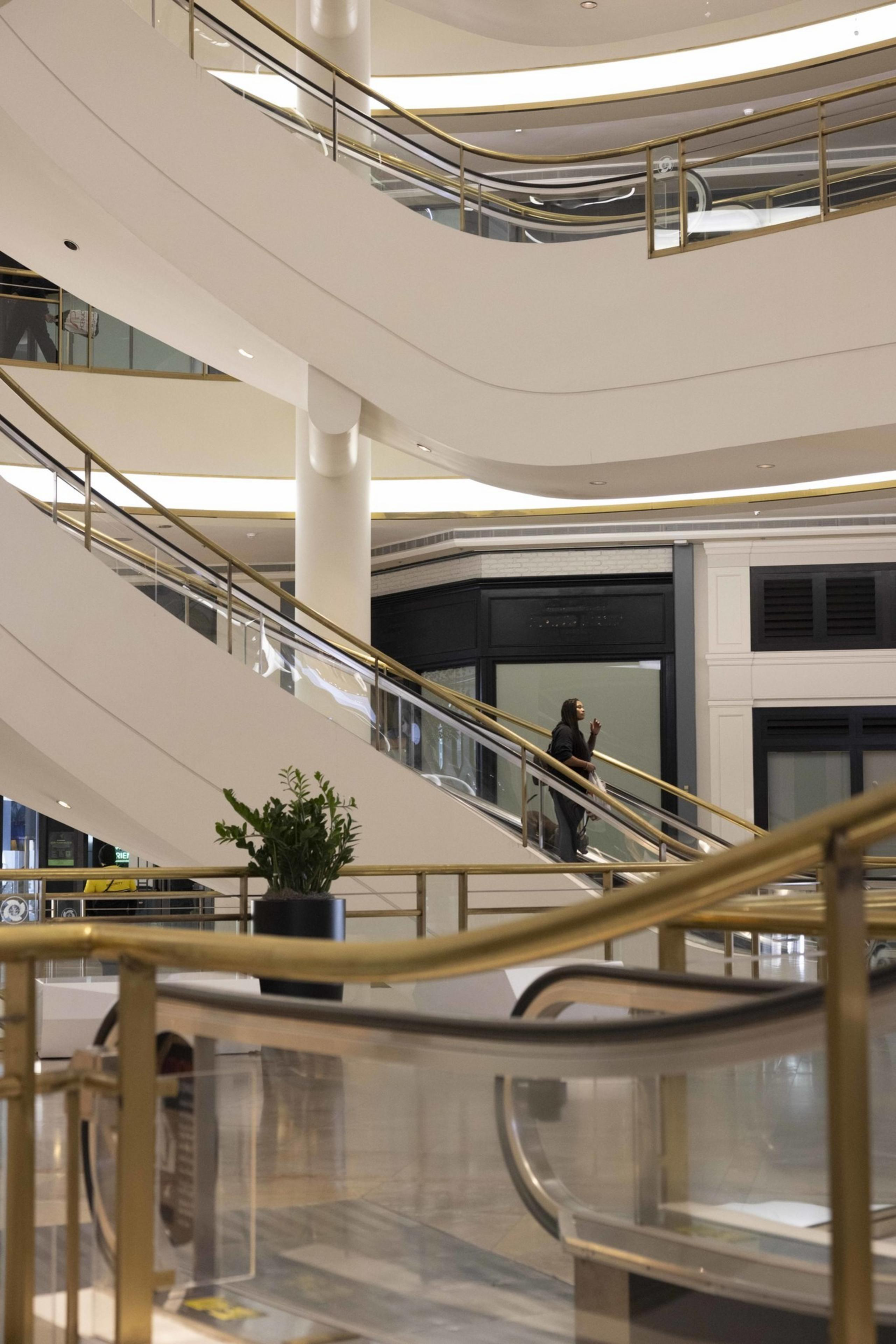 A person rides down the escalator at San Francisco Centre on Thursday, Oct. 24, 2024. The mall, which has been under receivership, is up for auction next month.