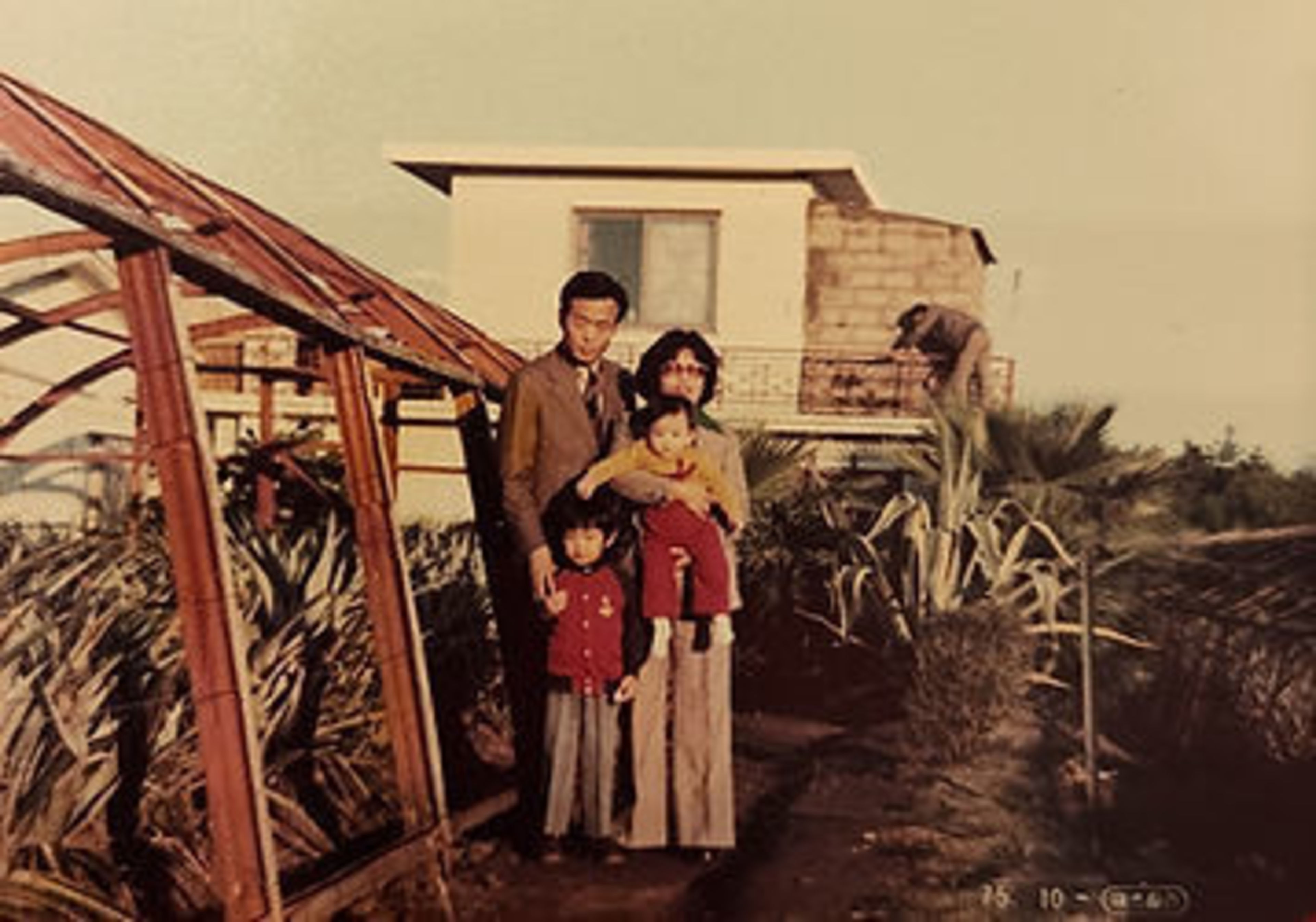 A family stands for a portrait. 