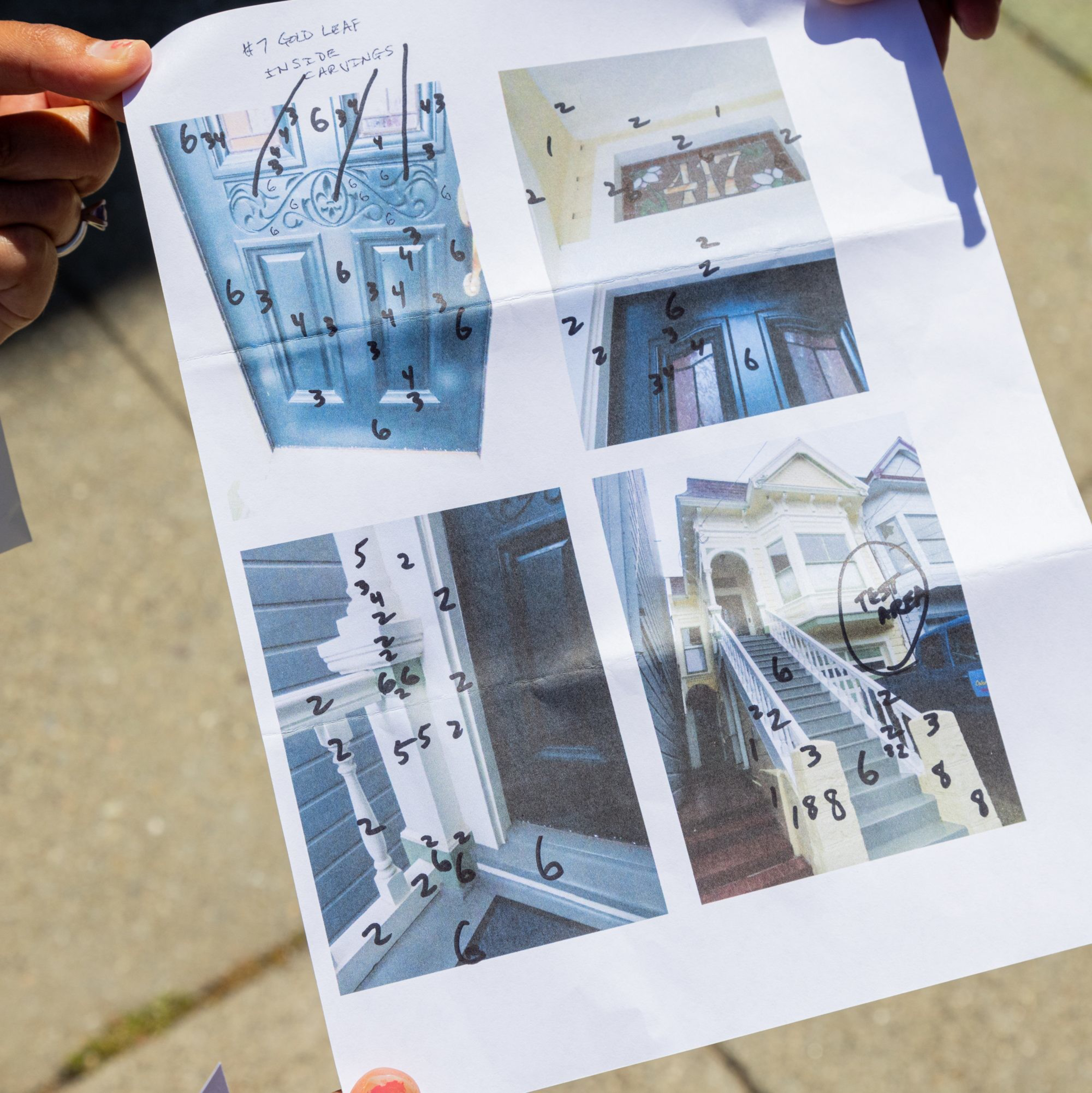 A hand holds a paper with photos of staircases, each marked with numbers for steps.