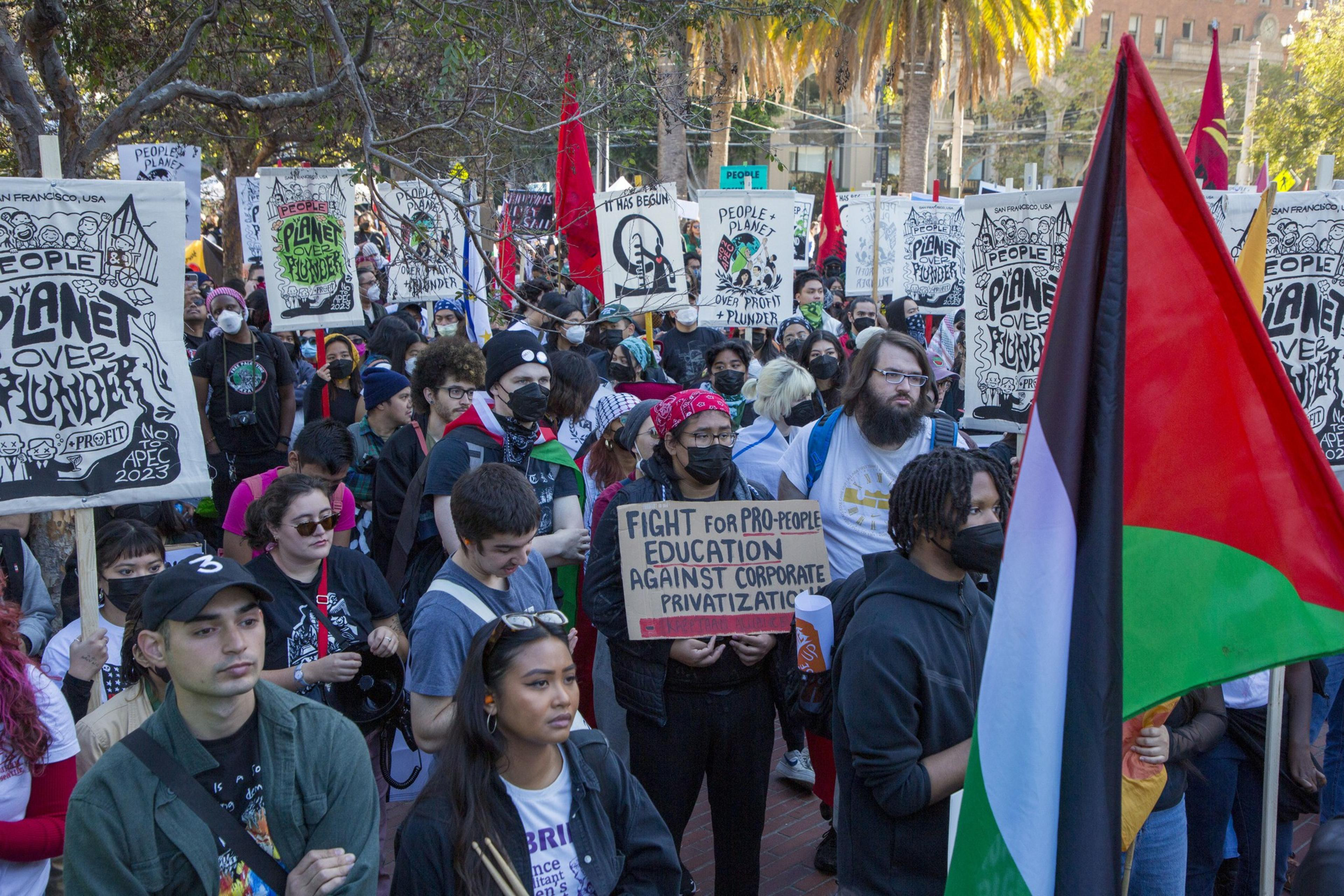 Thousands of people marched through San Francisco holding signs that read &quot;Planet over Plunder&quot; and &quot;No 2 APEC&quot;.