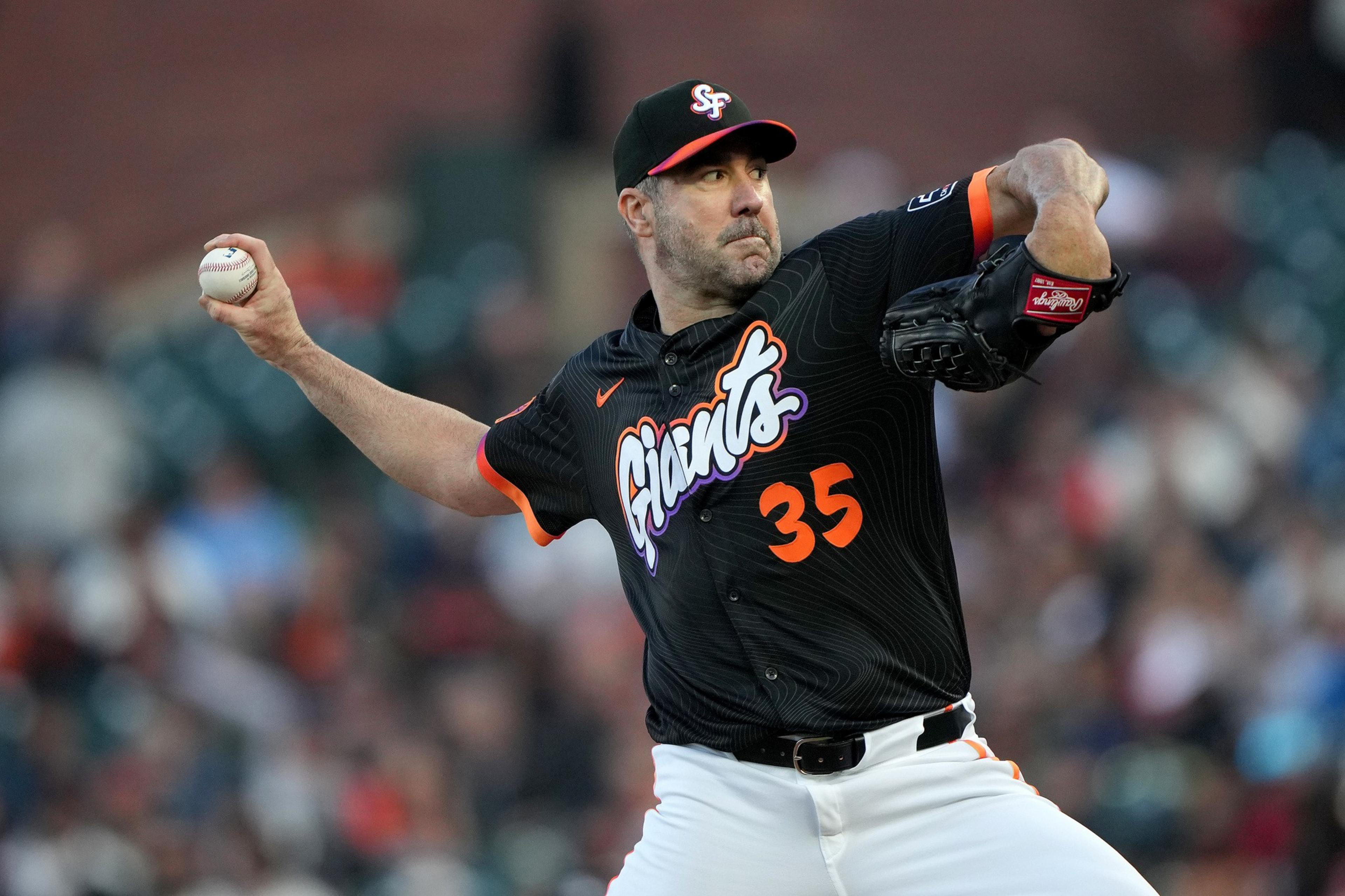 A baseball player in a San Francisco Giants uniform, number 35, prepares to pitch the ball during a game.