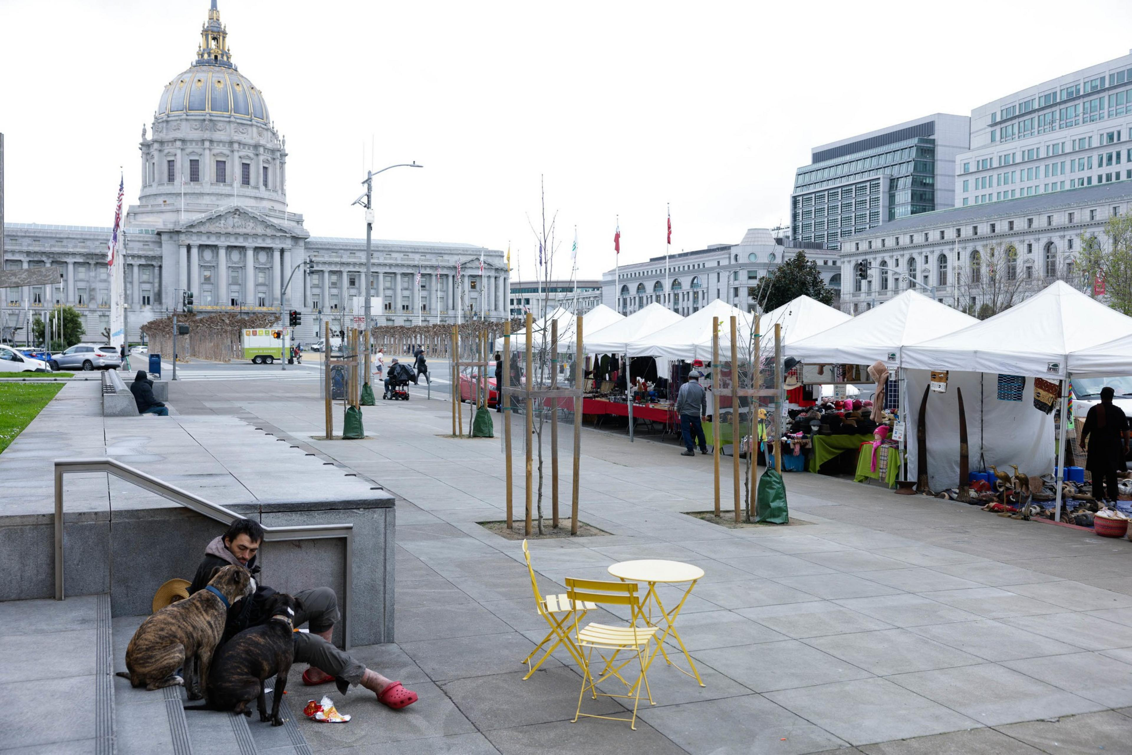 a row of white canopies at an outdoor market on a cloudy day near city hall's rotunda