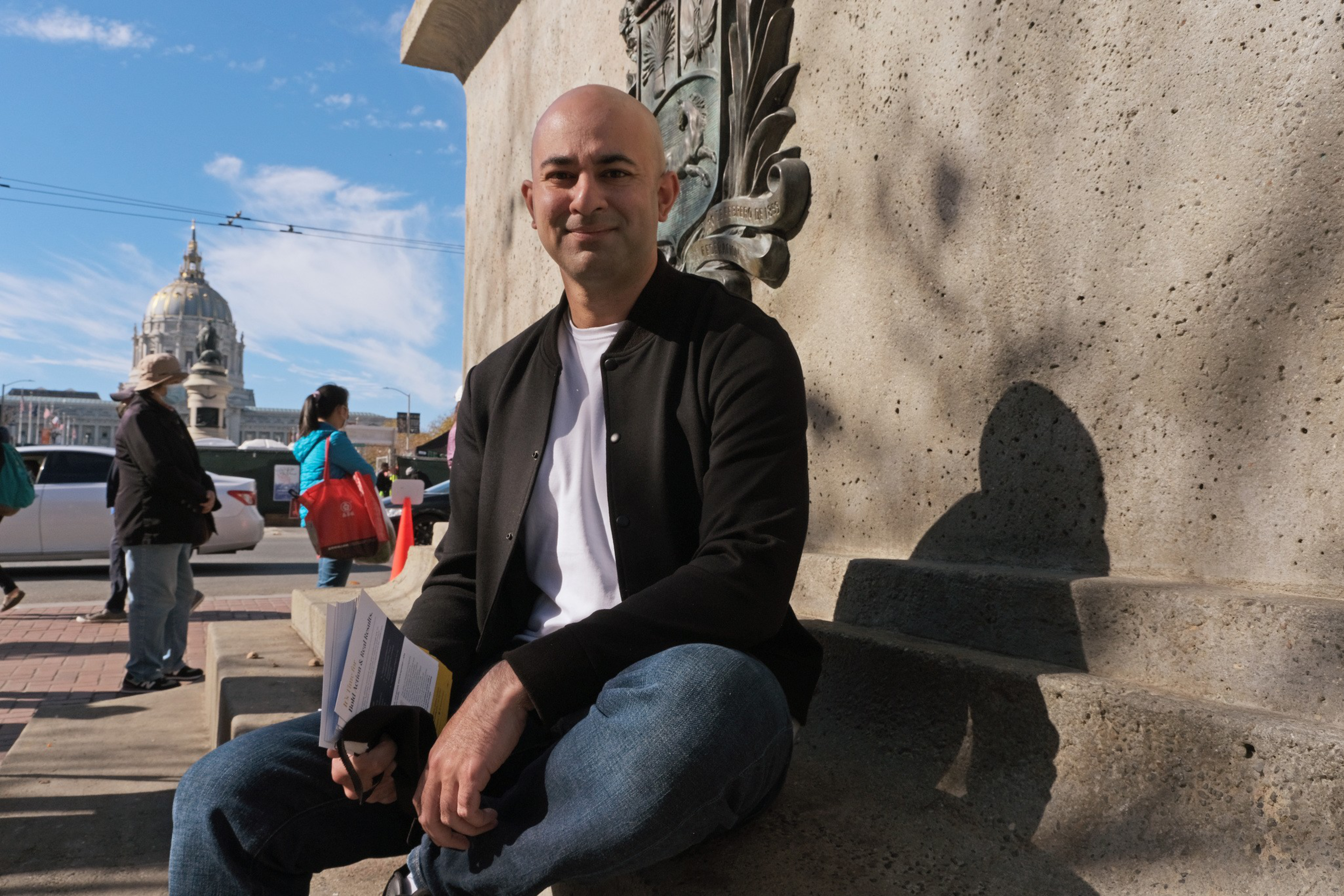 Bilal Mahmood sits in front of City Hall.