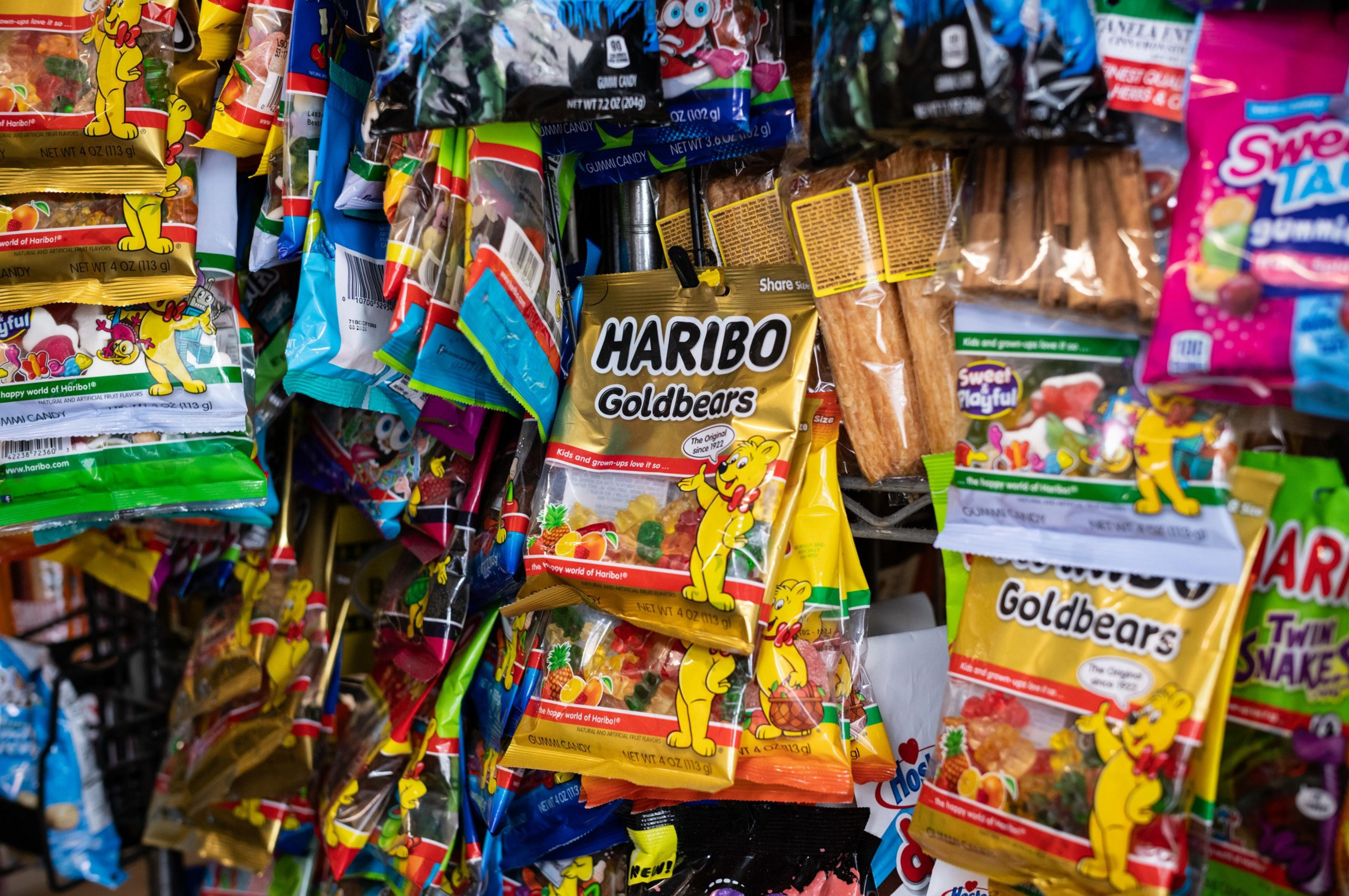 A display of colorful candy packages, with Haribo Goldbears at the forefront.