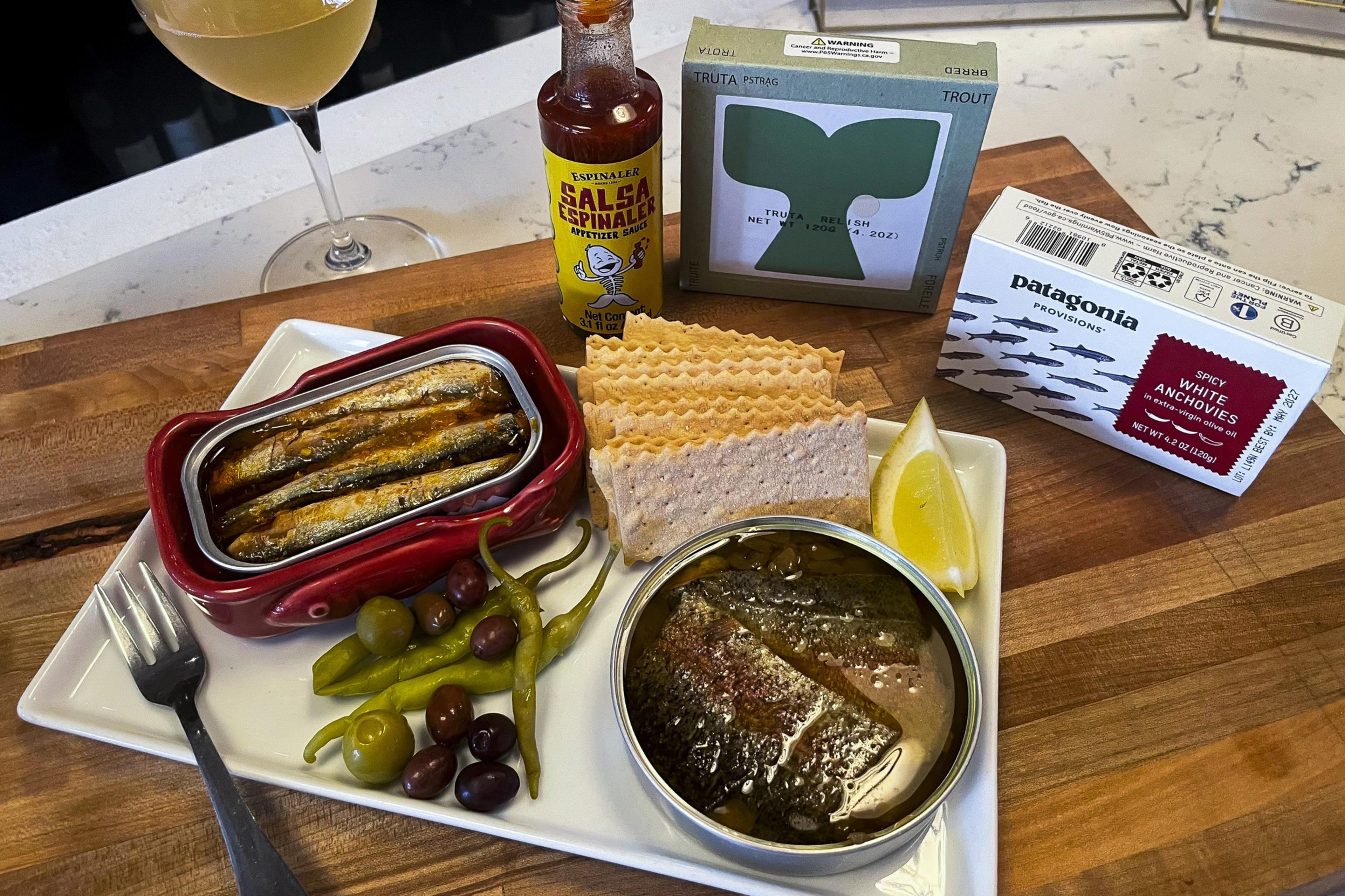 A plate with tinned fish items.