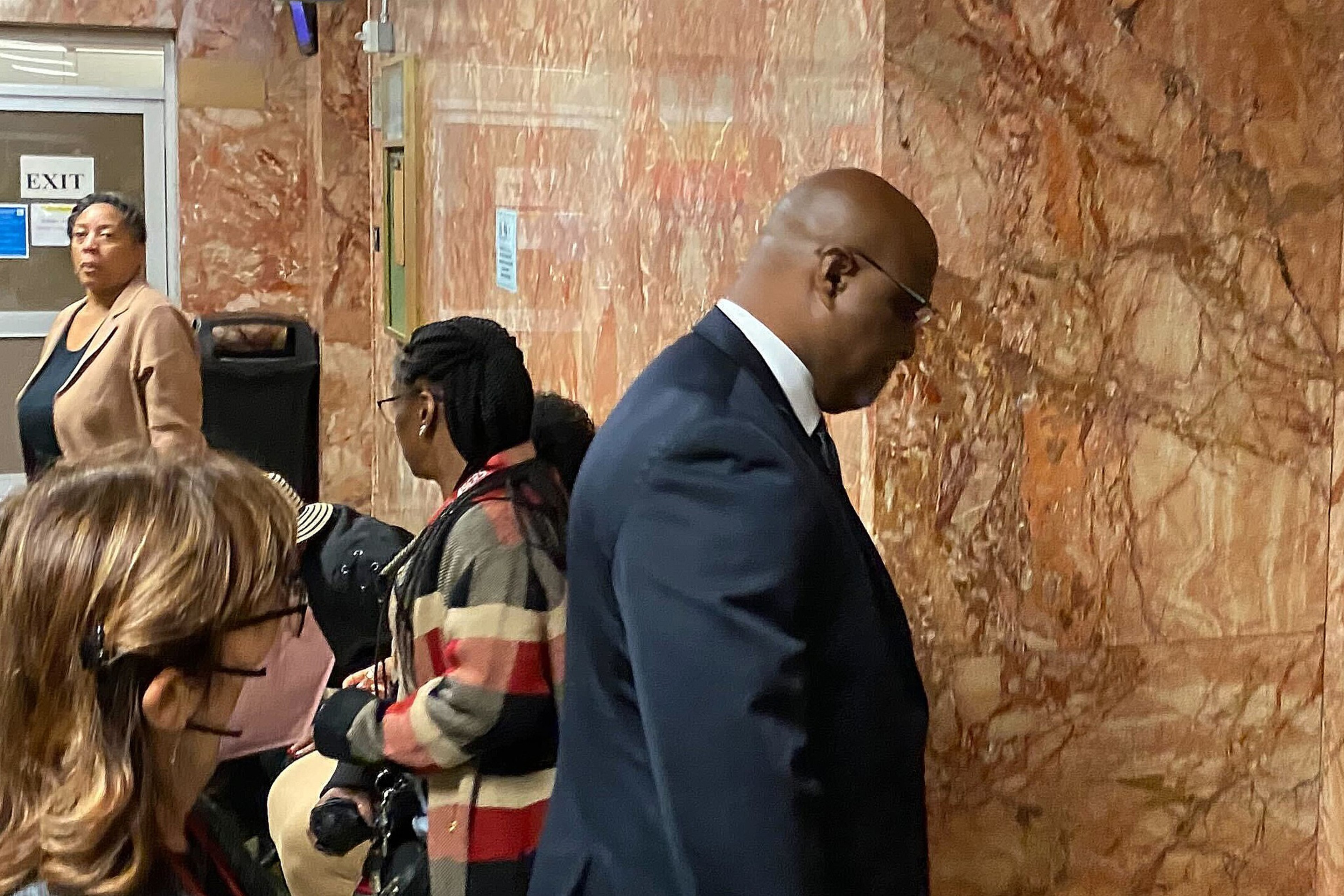 A man walks into a courtroom.