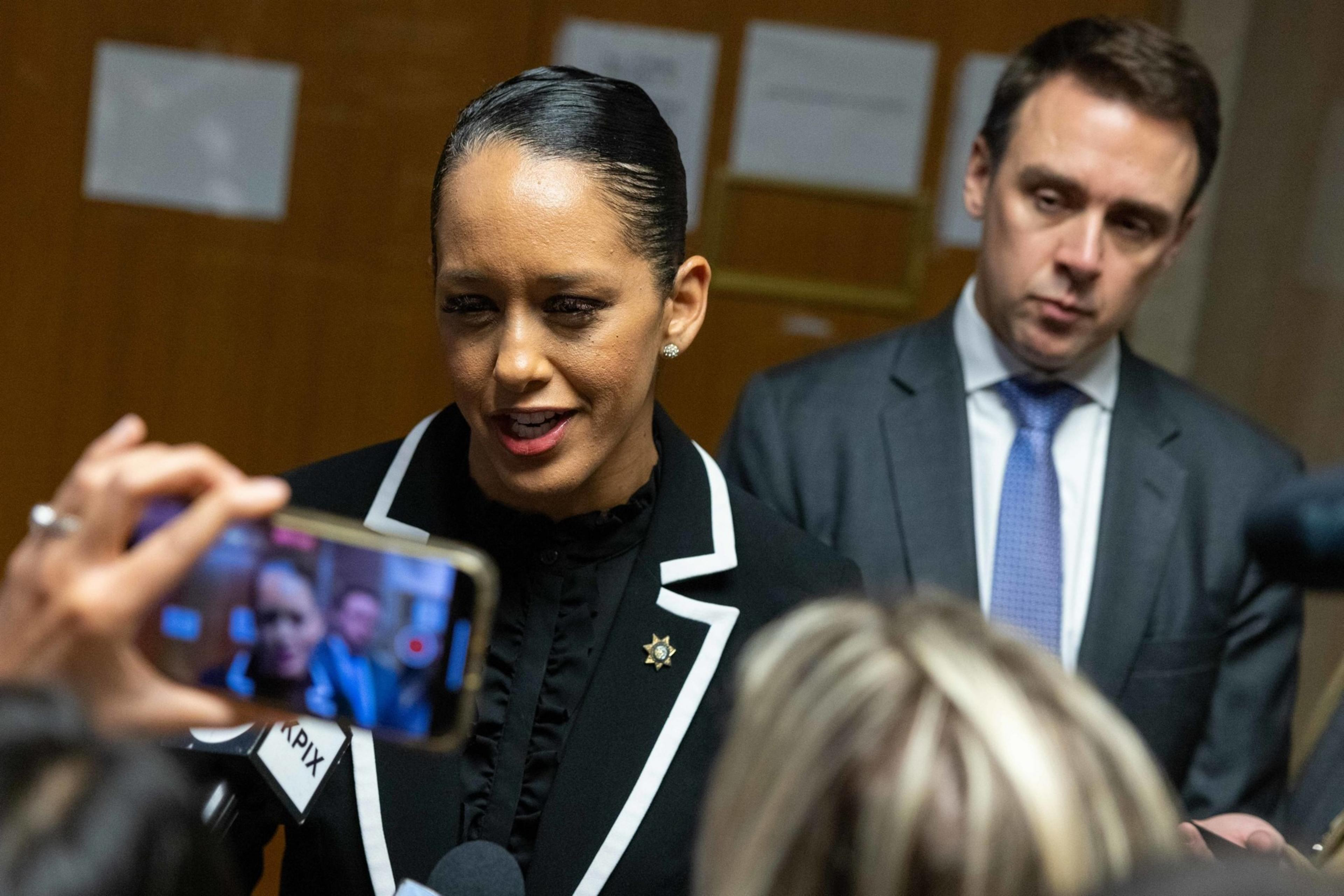 District Attorney Brooke Jenkins speaks to a scrum of reporters