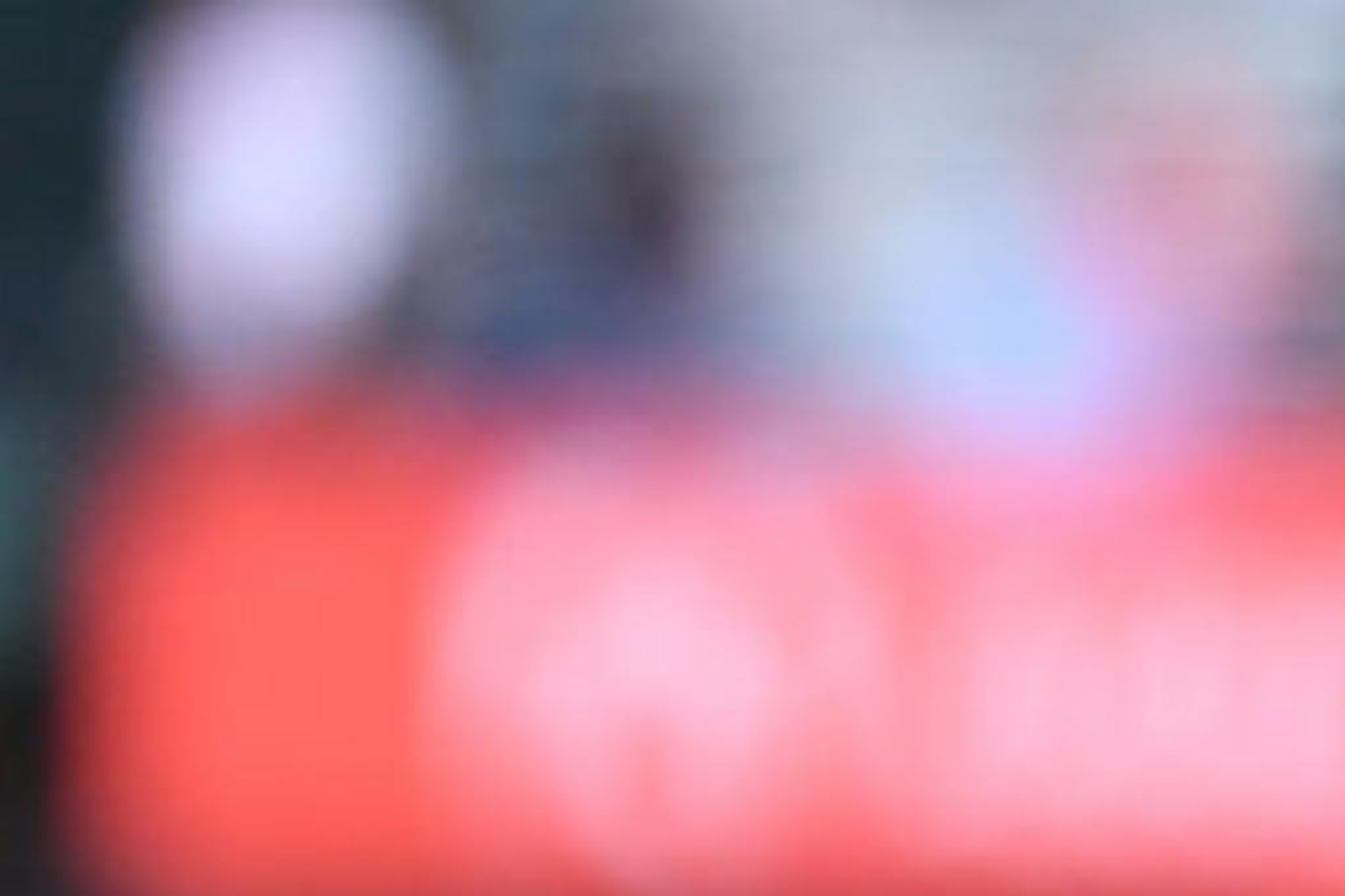 A person stands at a podium labeled "Oracle Park" with two microphones. The background is a blurred view of a sports field.