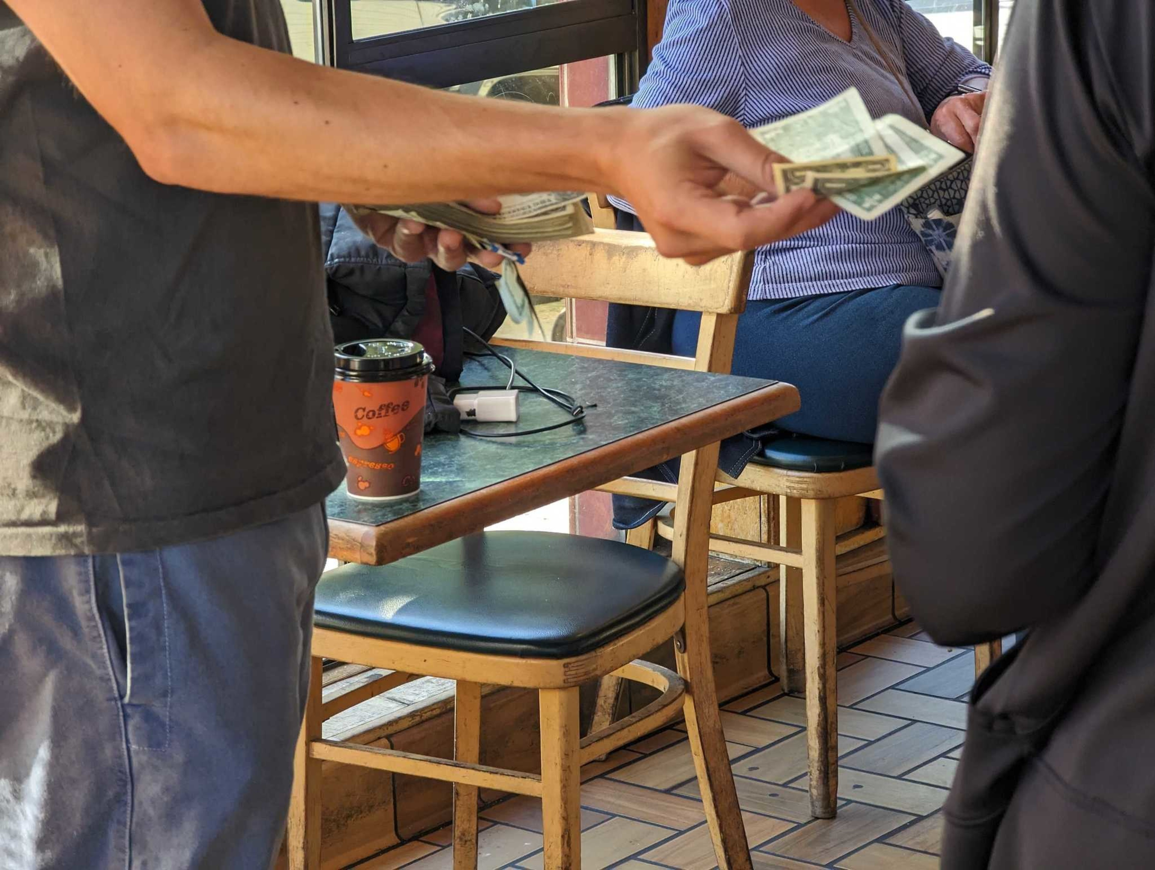 Julian Weisser greeted visitors to Happy Donuts for an hour Wednesday with an offer to pay for customers' doughnuts.