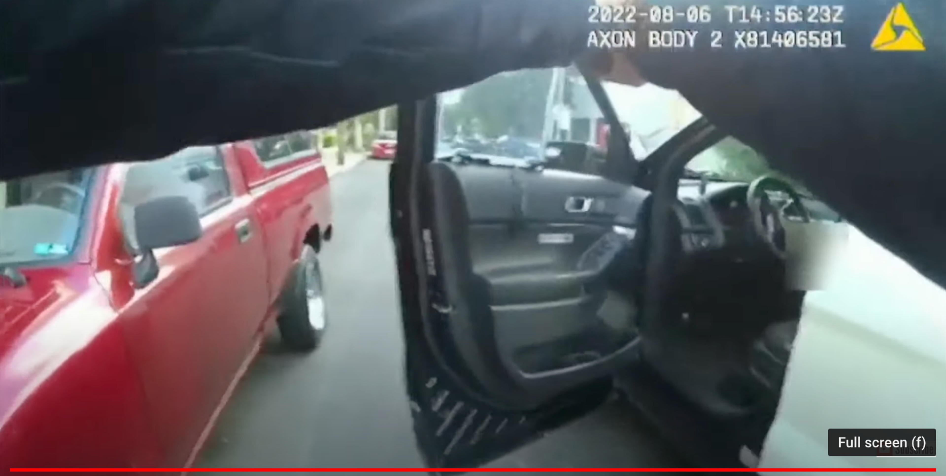 A still from bodycam footage shows an officer drawing their gun.