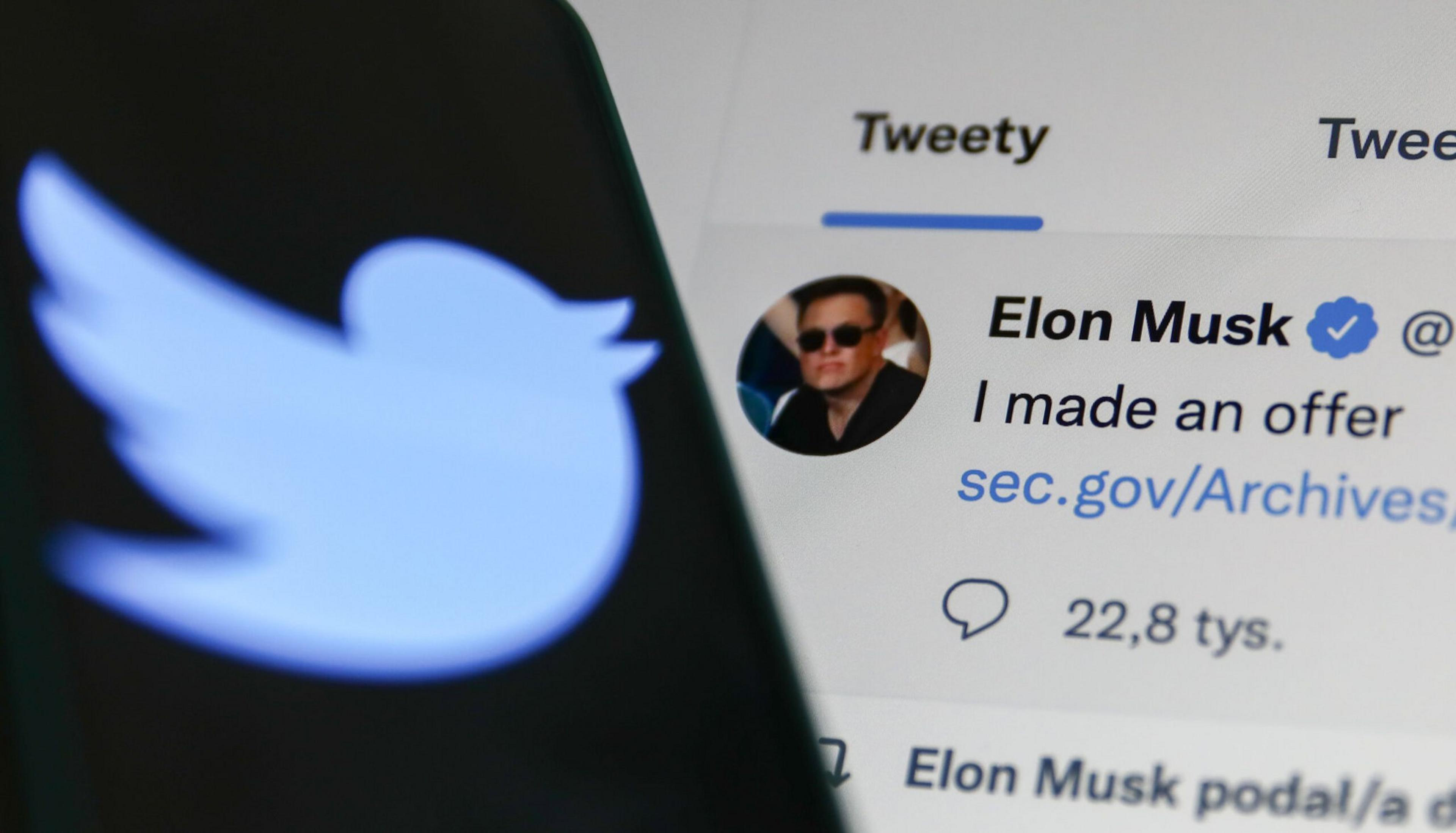 A blurred Twitter logo appears on a phone screen beside Elon Musk's verified tweet stating, "I made an offer," with a link and 22.8k replies.