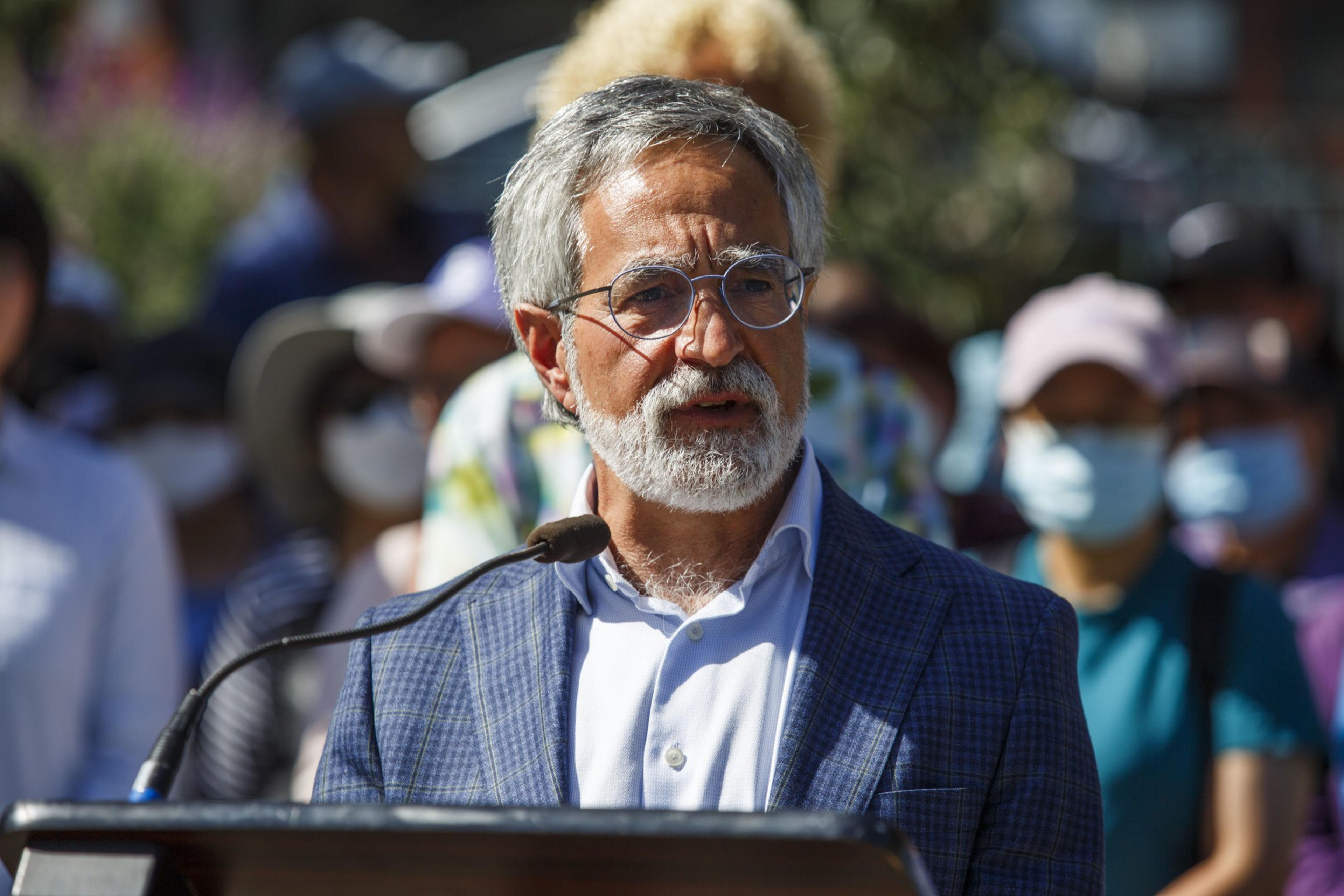 Aaron Peskin speaks to a crowd outside City Hall. 