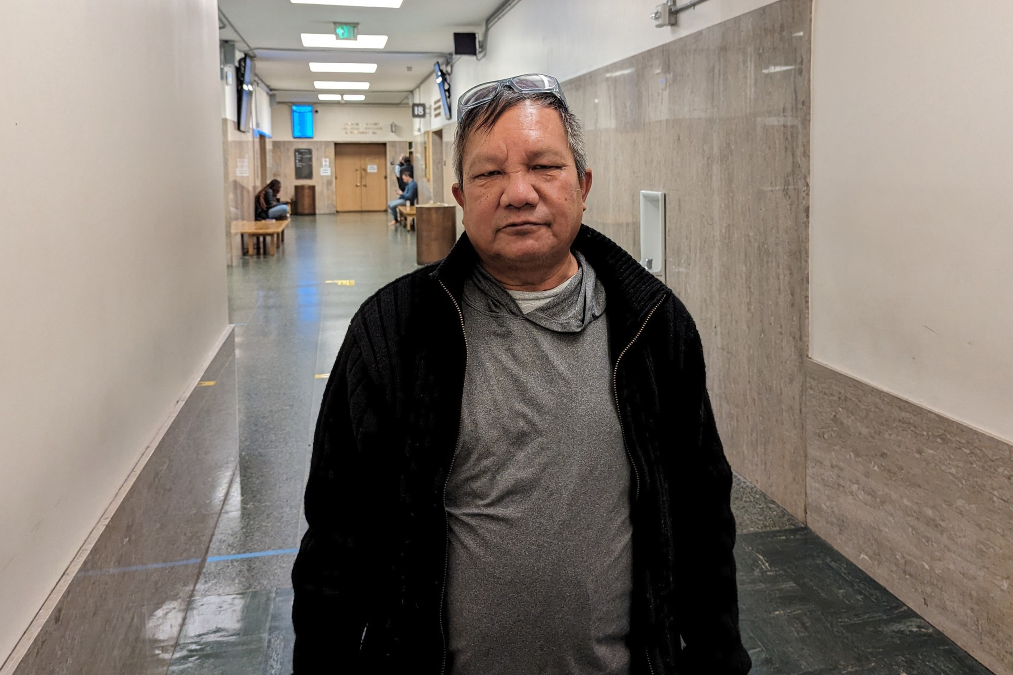 A man stands in a hallway.