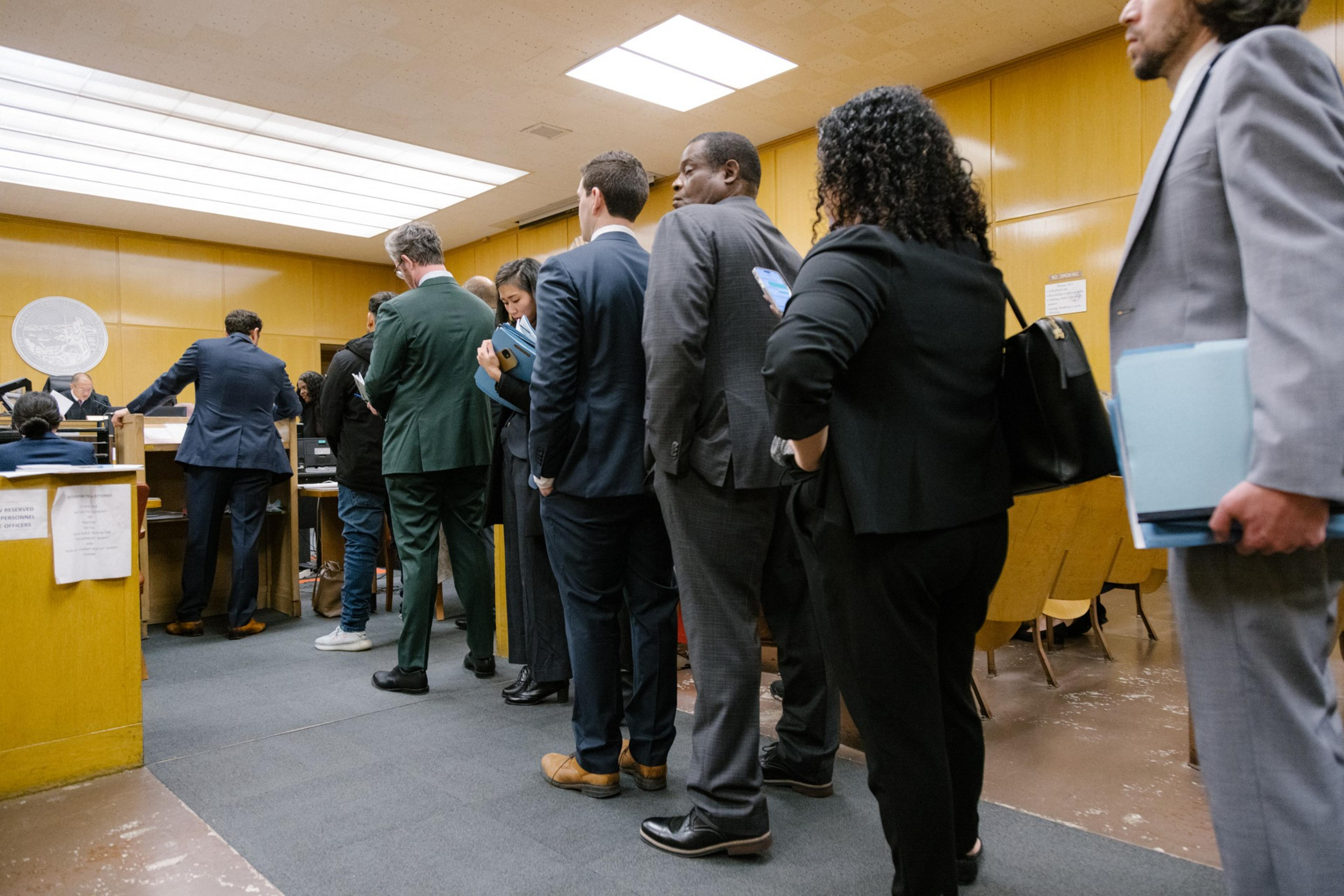 Attorneys wait to have their cases heard in court.