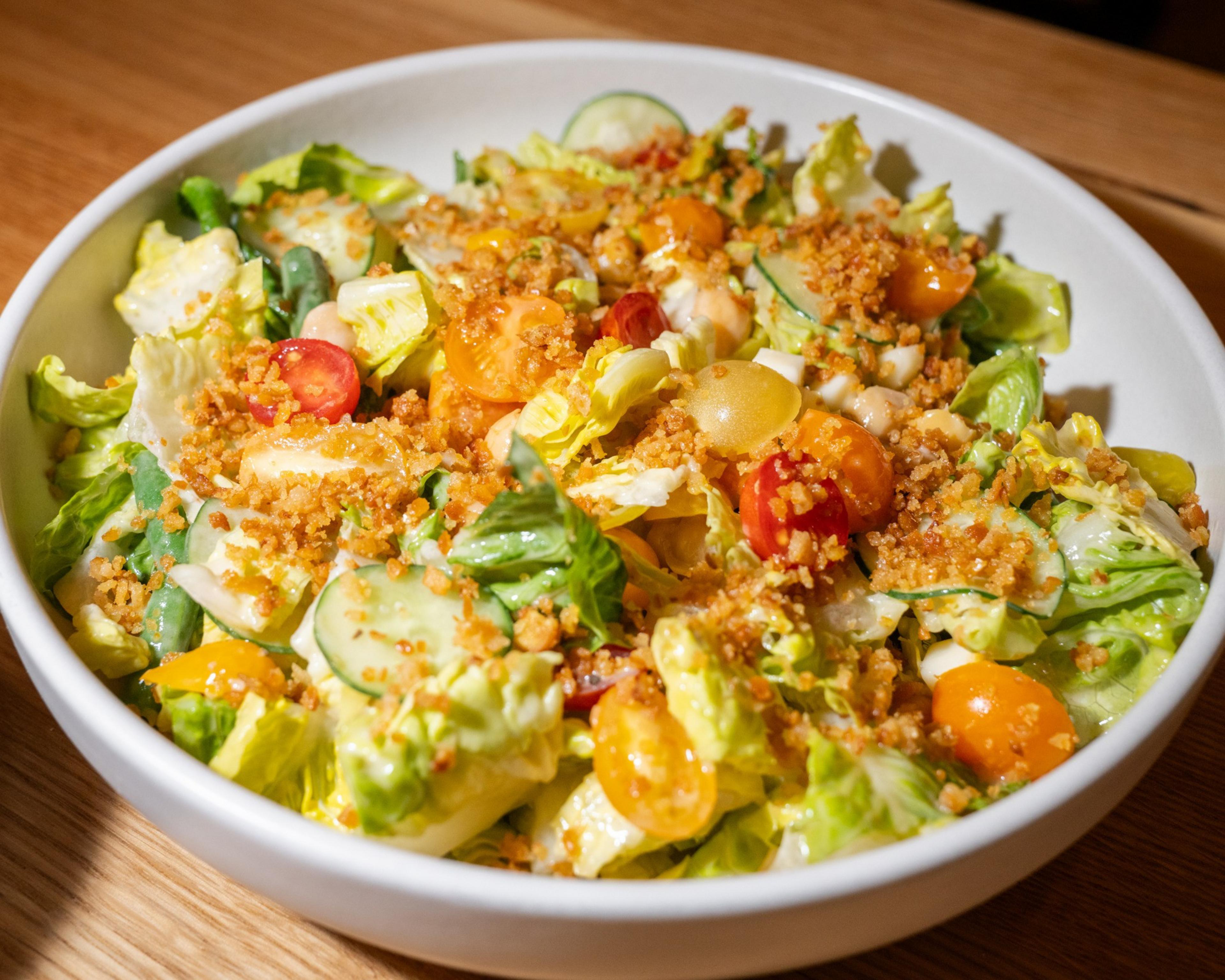 A summer chop salad features market veggies, chickpeas, pepperoncini, parm frico and creamy Italian dressing.