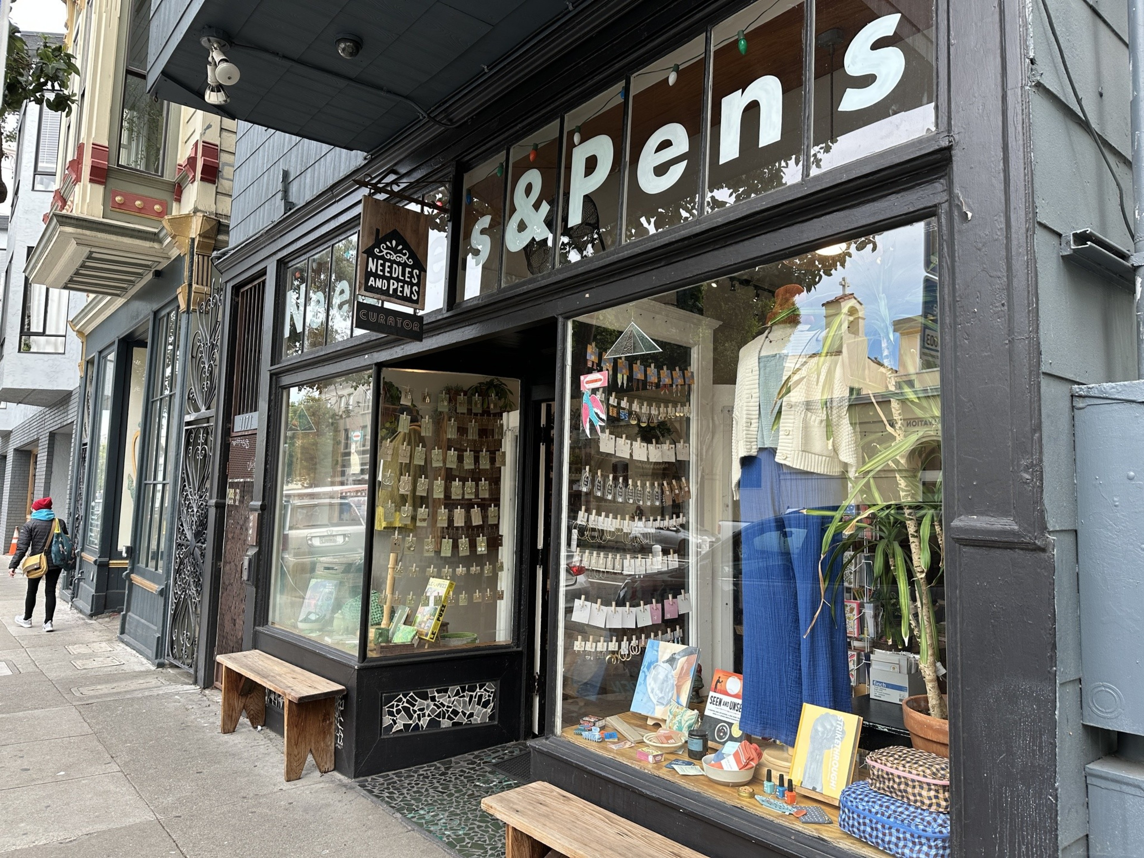 A gift shop storefront with books and mannequins wearing artsy clothes on Valencia Street in San Francisco. 