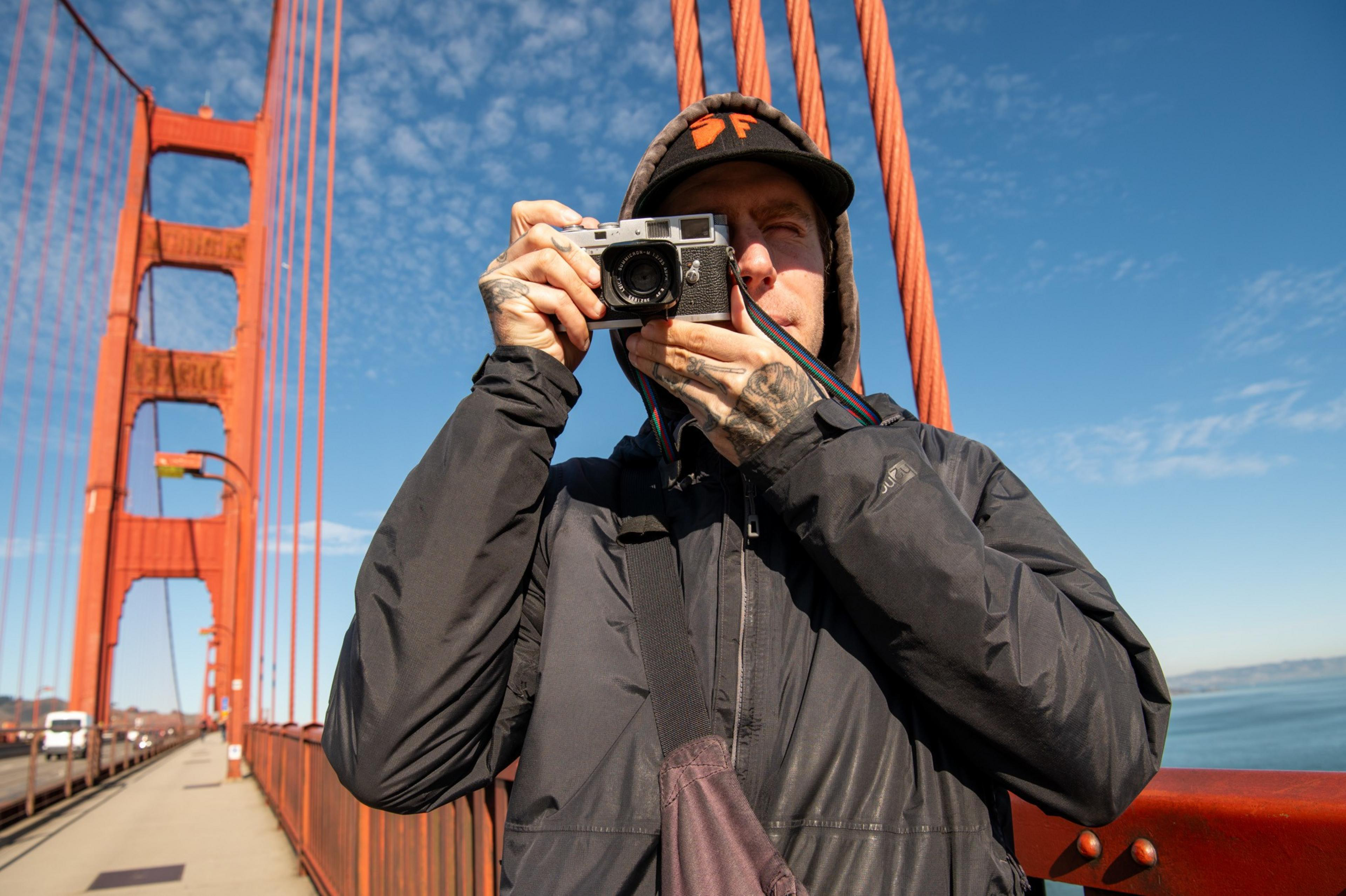 Jake Ricker looks through the viewfinder of his camera on the bridge on Dec. 12. 