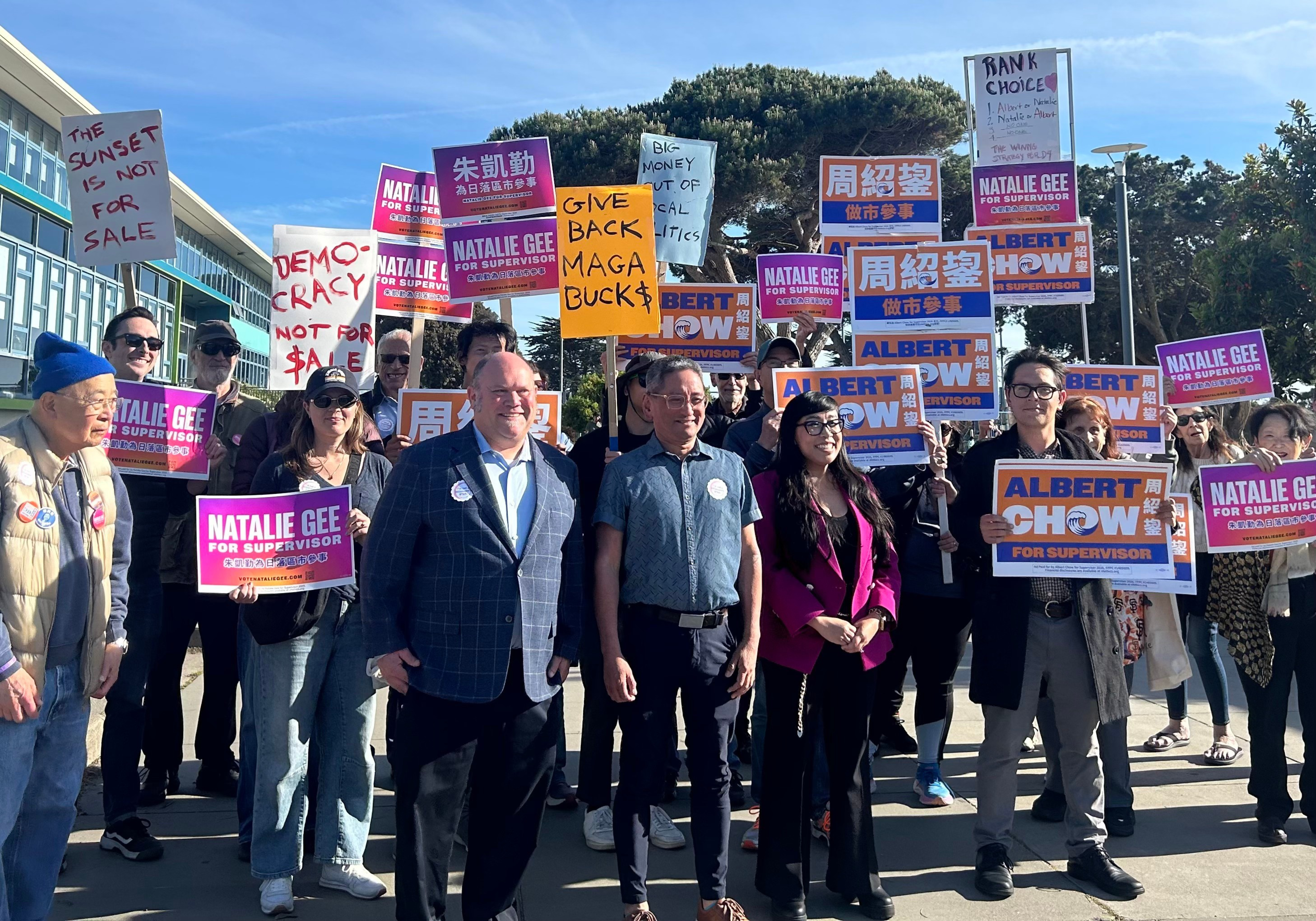A diverse crowd holds signs supporting Natalie Gee and Albert Chow for supervisor, with additional signs opposing MAGA money and advocating democracy.