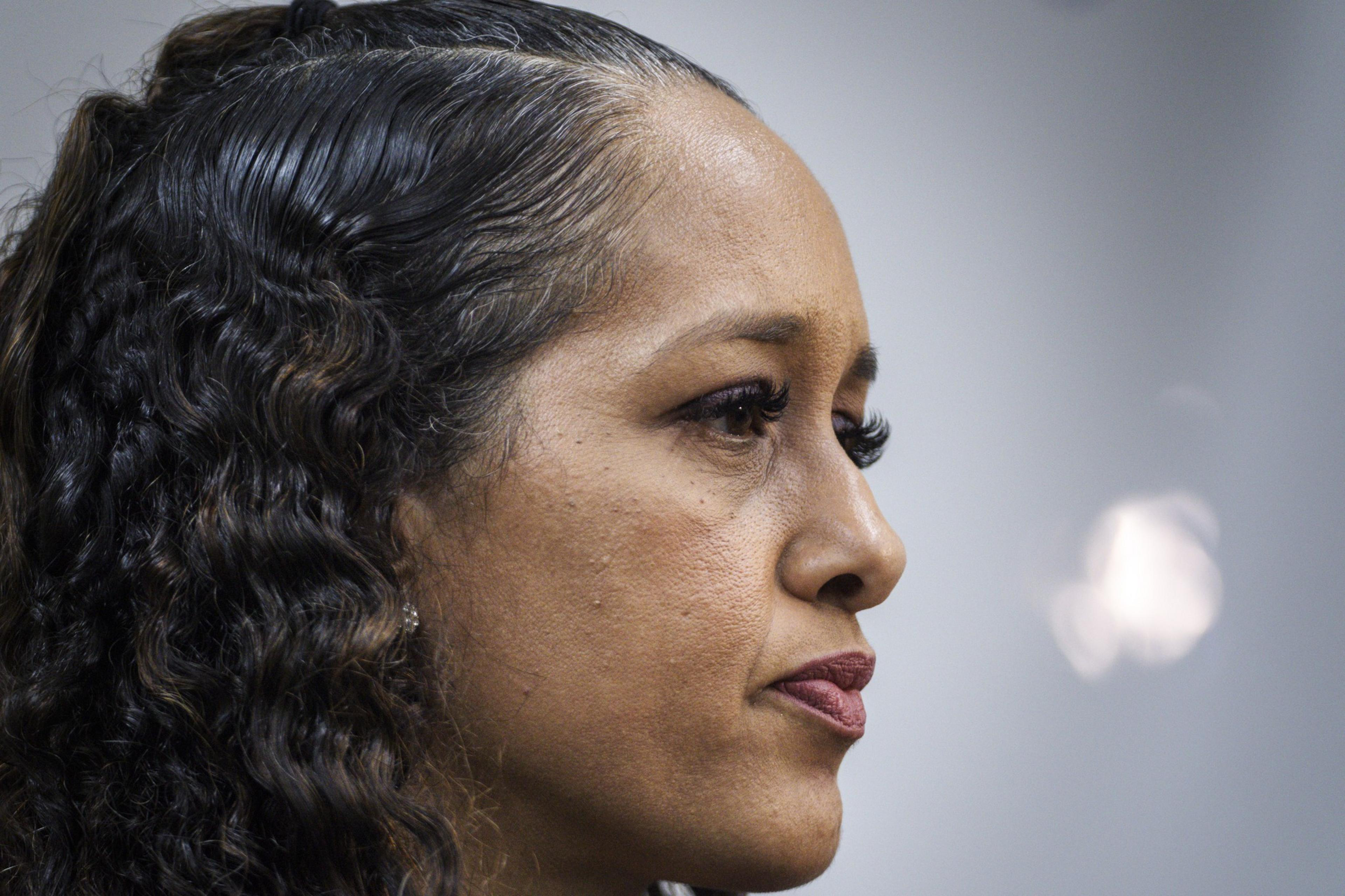 A woman looks to the right. 