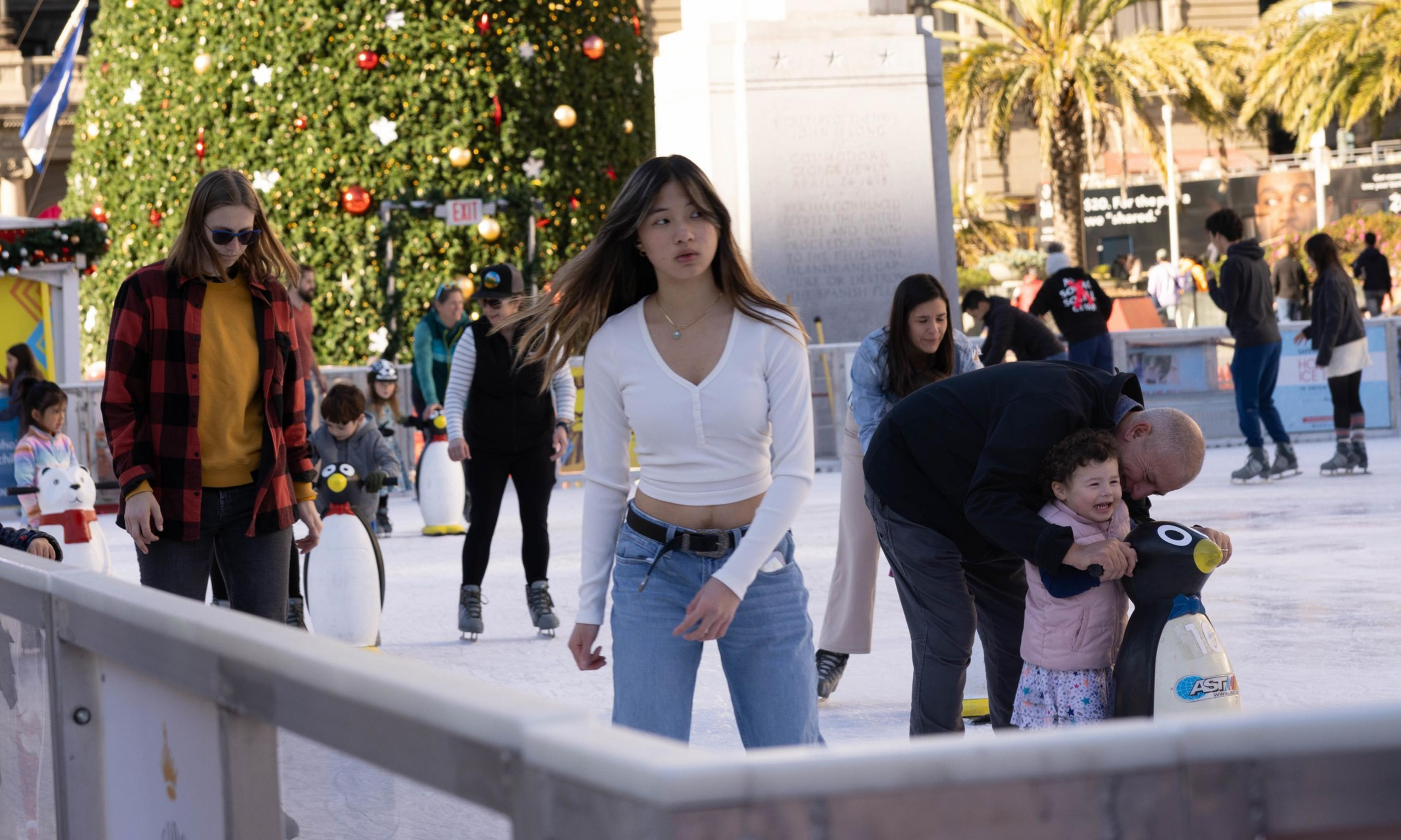 People of various ages skate at Union Square's ice skating rink.