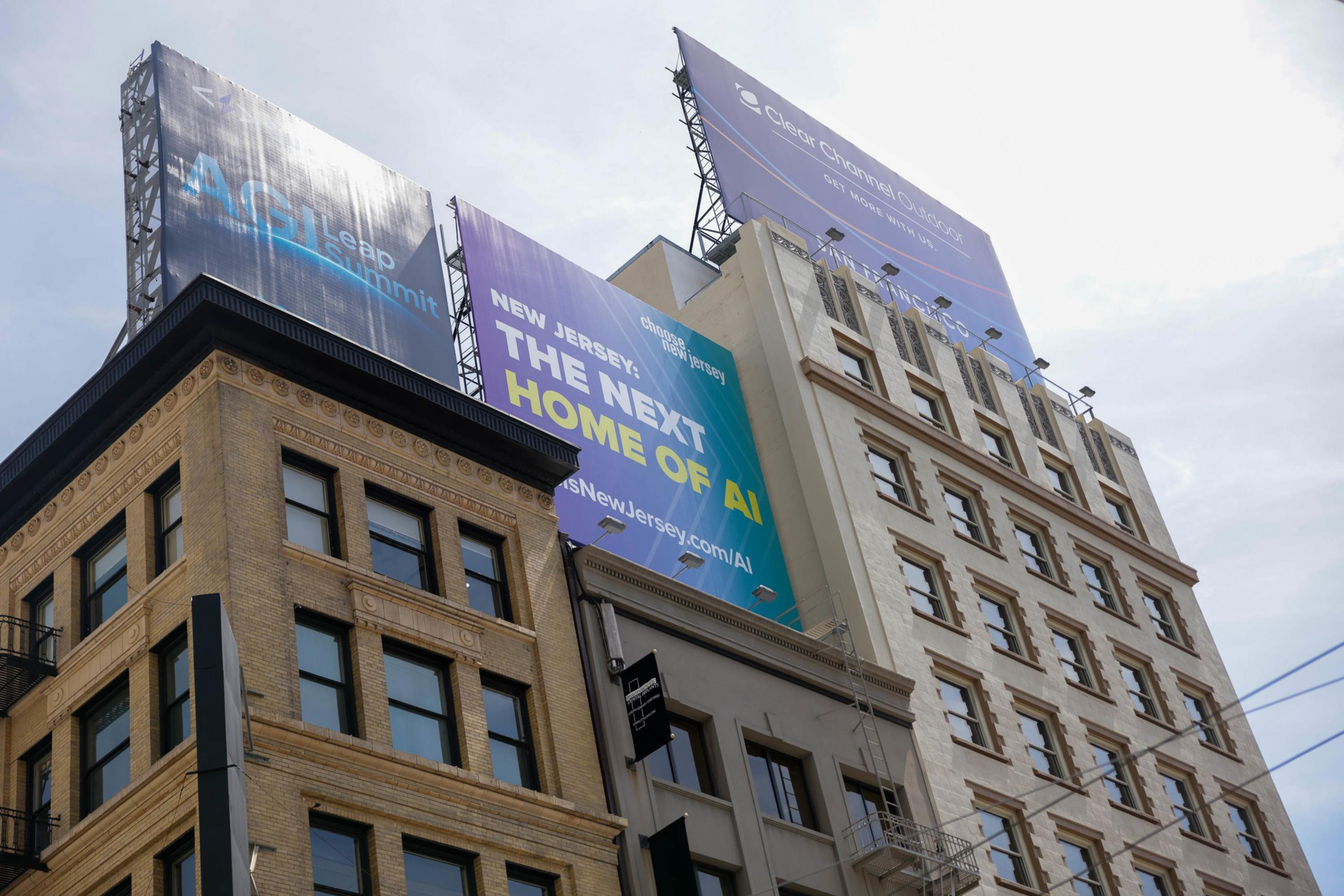 A billboard promoting New Jersey as &quot;THE NEXT HOME OF AI&quot; next to a classic building, with a web address for more info.