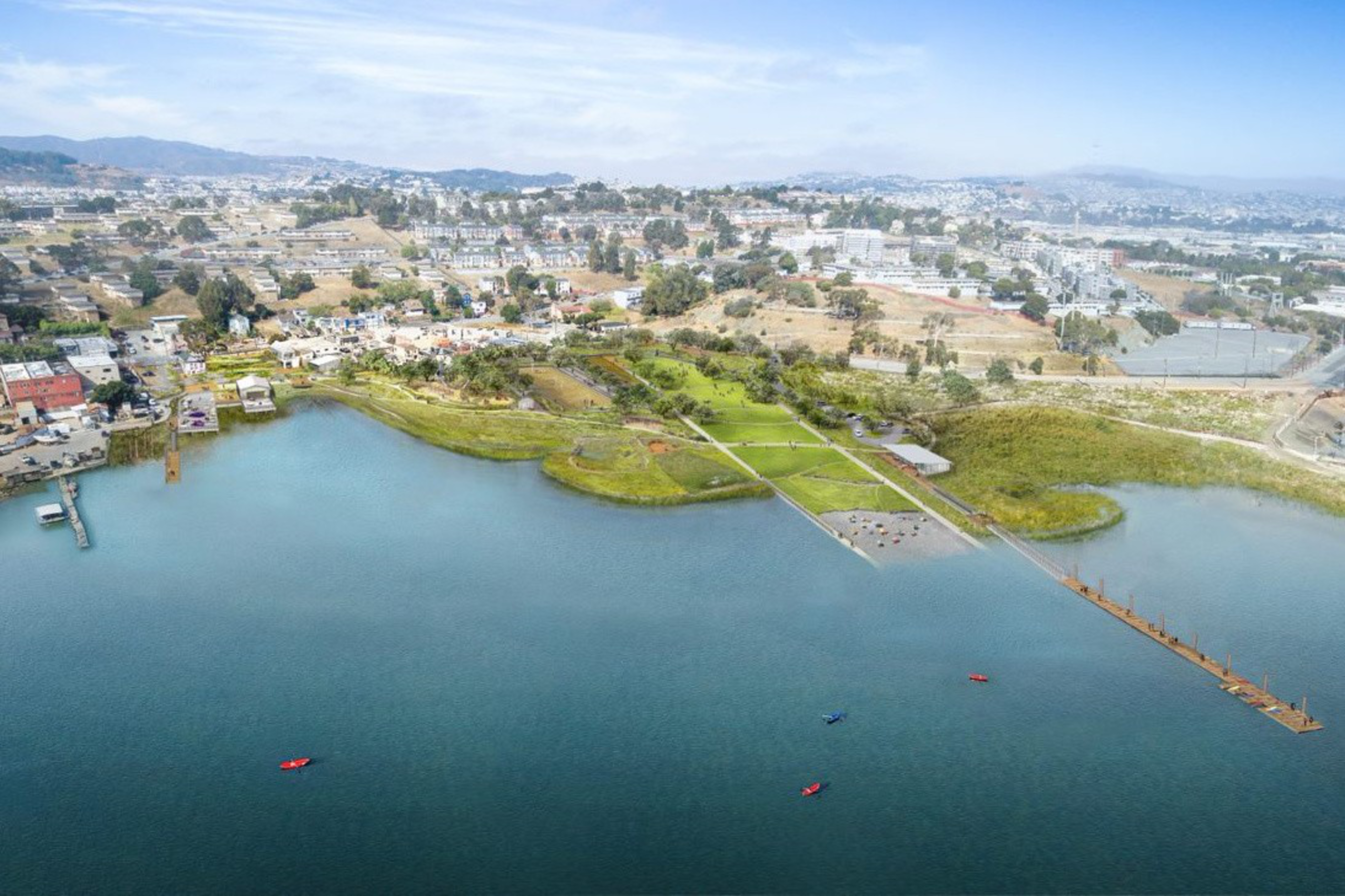 A waterfront park with green grassy areas, a long dock extending into a body of water, and small kayaks or boats floating nearby, backed by city buildings.