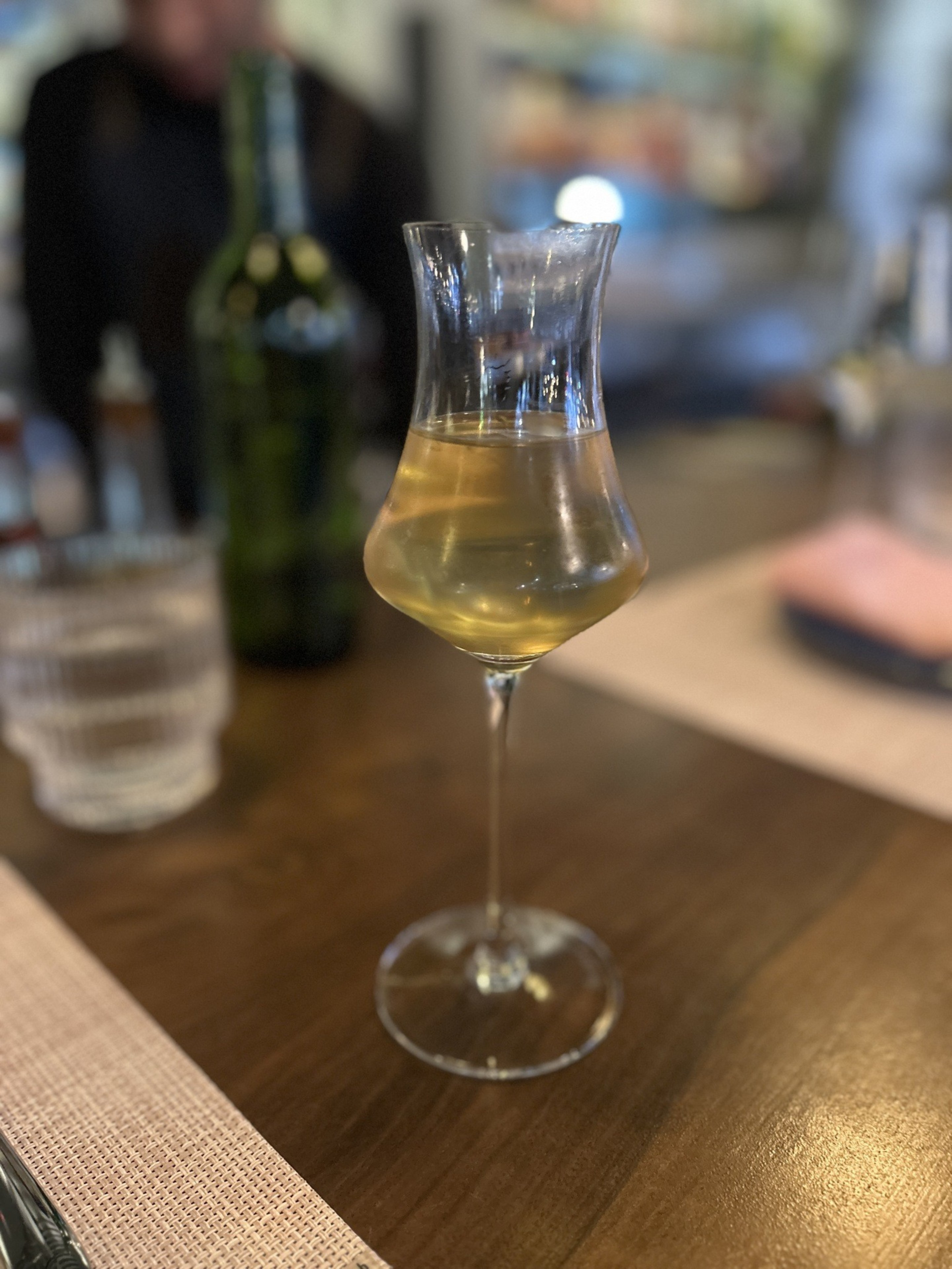 A cocktail in a fluted glass on a table.