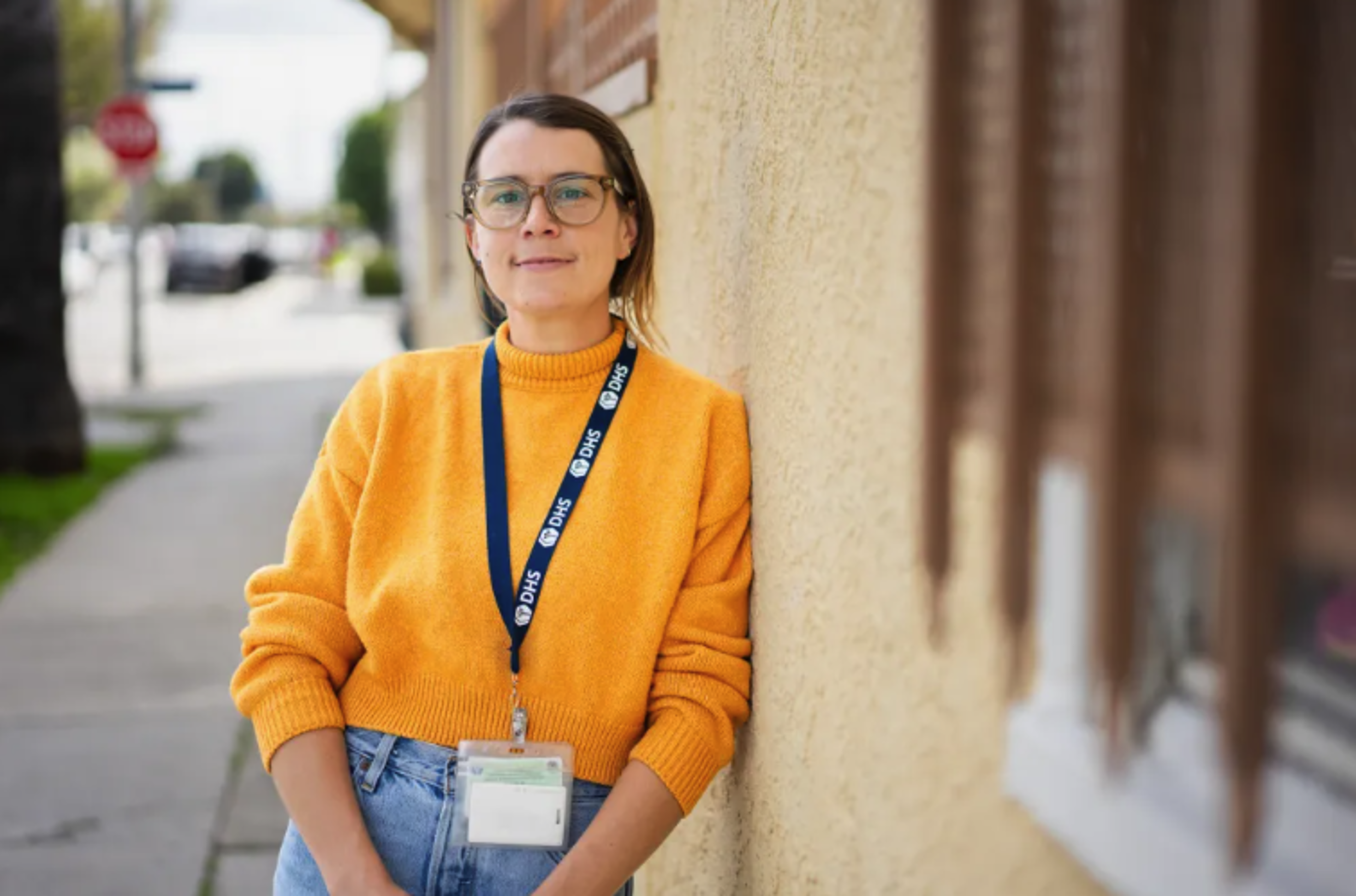 Woman stands outside building