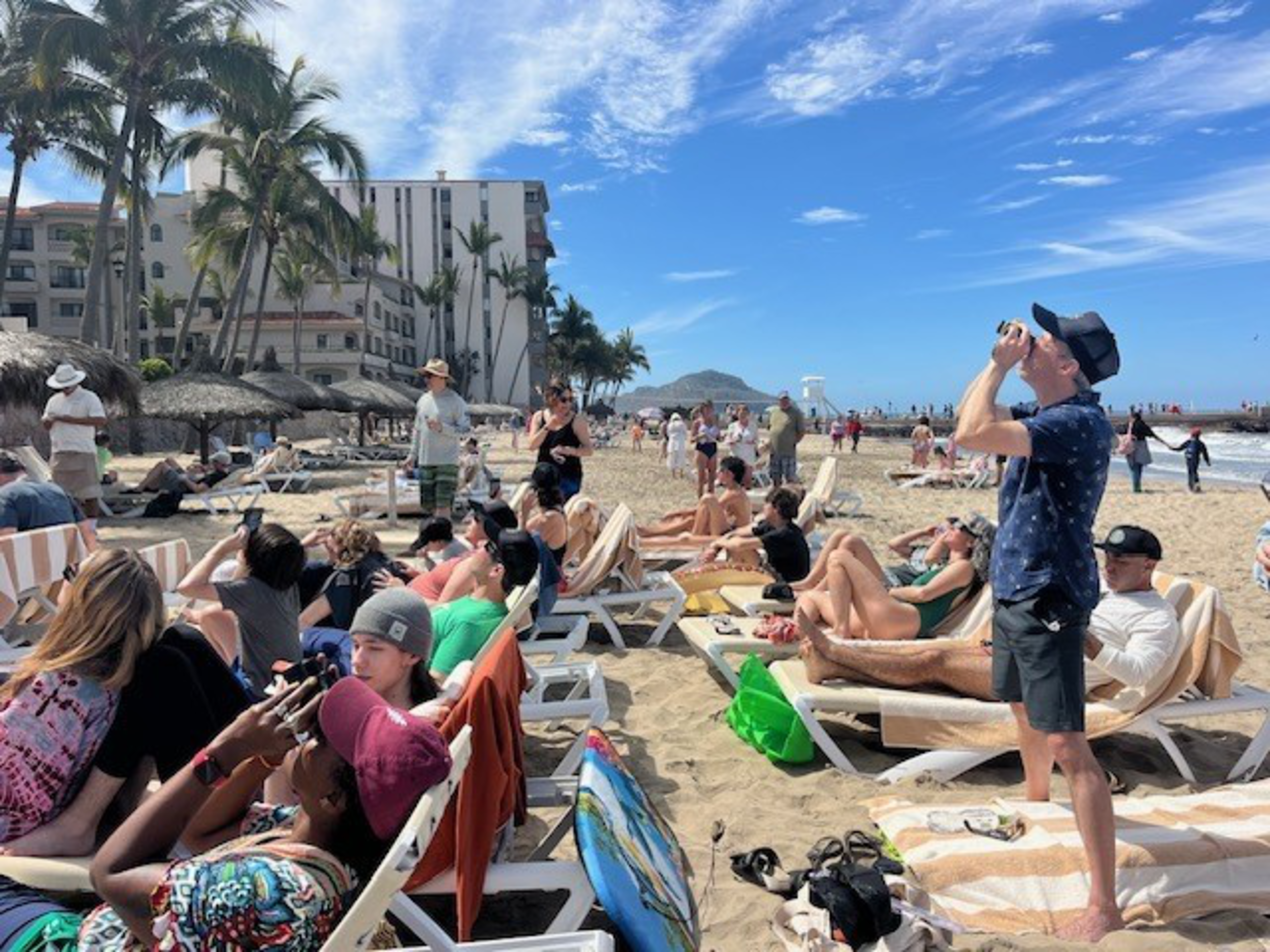 People watch the eclipse from the beach at Mazatlan, Mexico