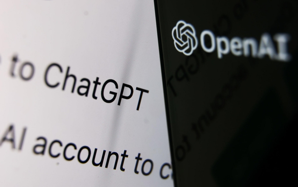 The OpenAI logo and text appear on a dark screen edge next to blurred black text on a white background mentioning ChatGPT and account creation.
