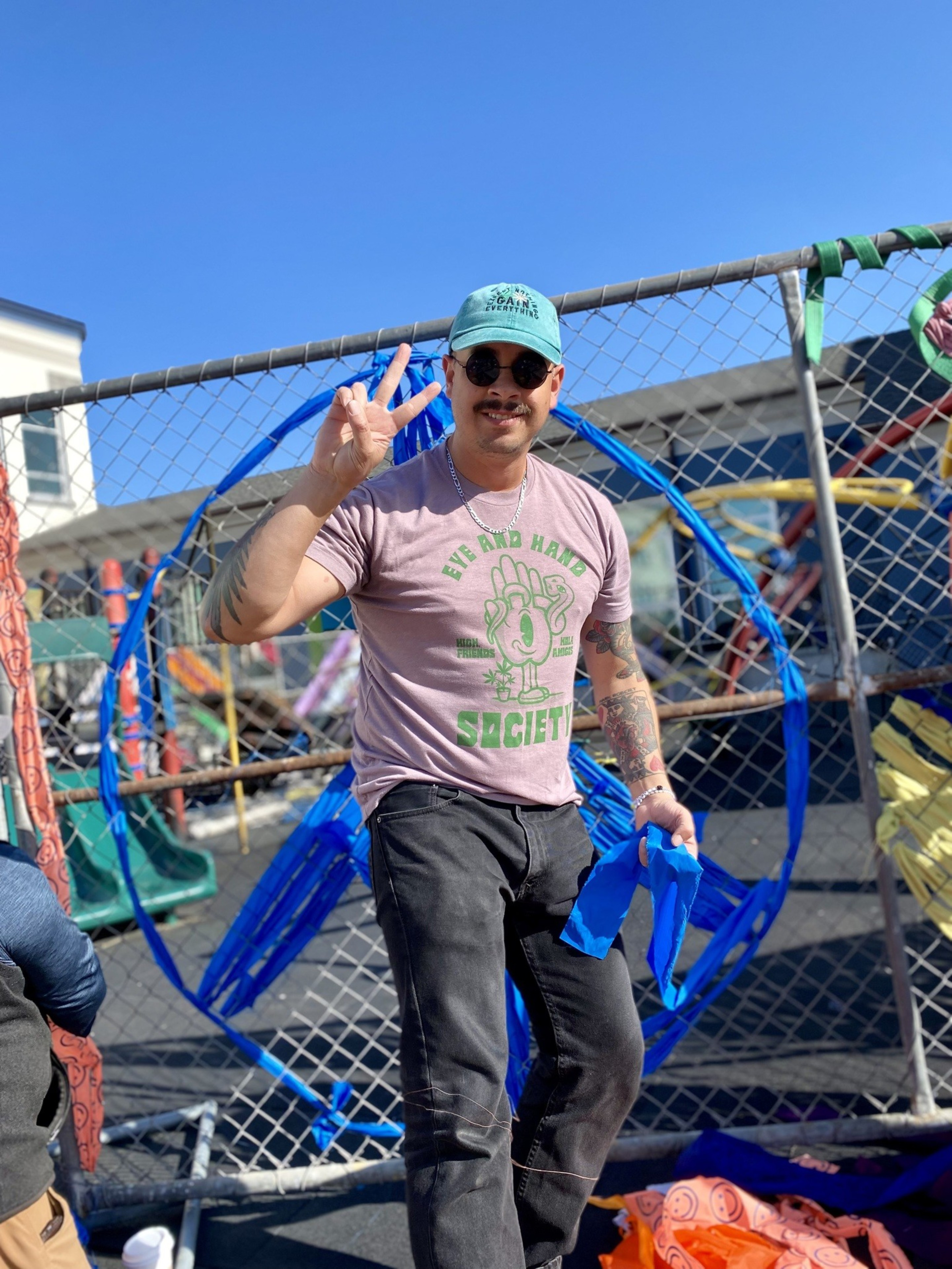 A photo of community members decorating a fence.