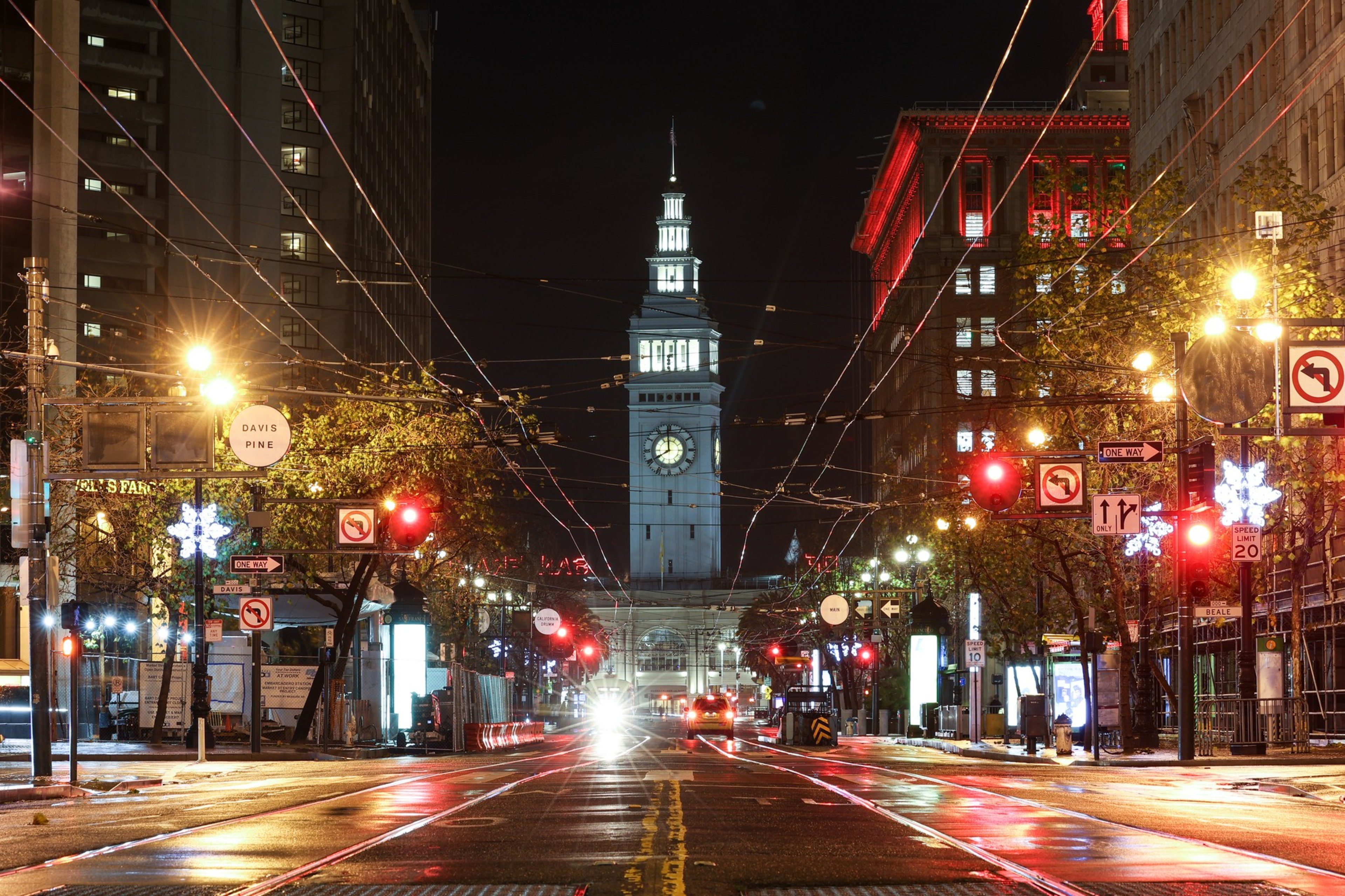 A long view of a commercial corridor at night. The streets are empty and lit with streetlights. 