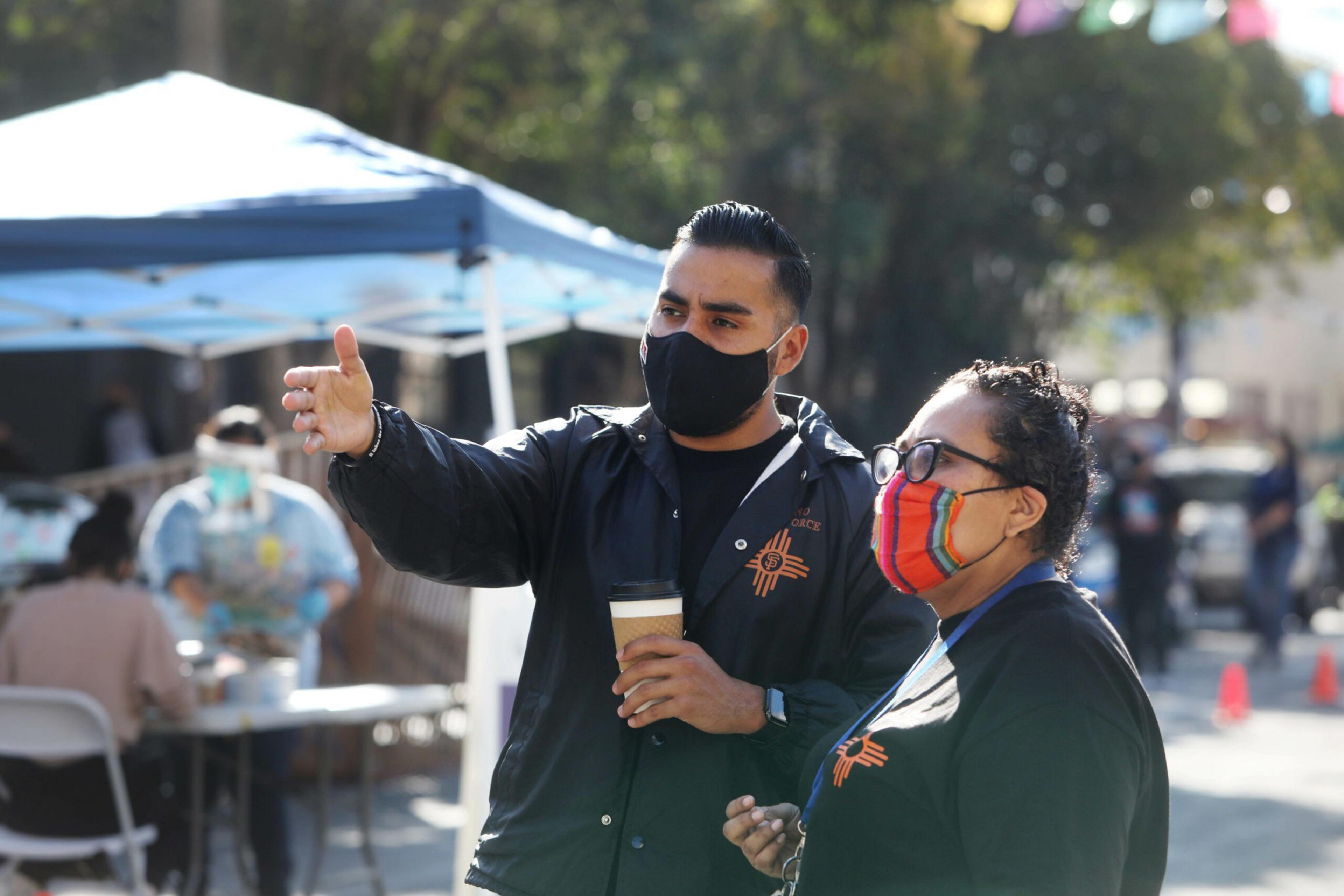 Jon Jacobo (l to r), chair of Latino Task Force health committee, talks with Susana Rojas, Latino Task Force communication chair, as they work at the Latino Task Force Resource Hub on Thursday, November 5, 2020 in San Francisco, Calif. (Photo By Lea Suzuki