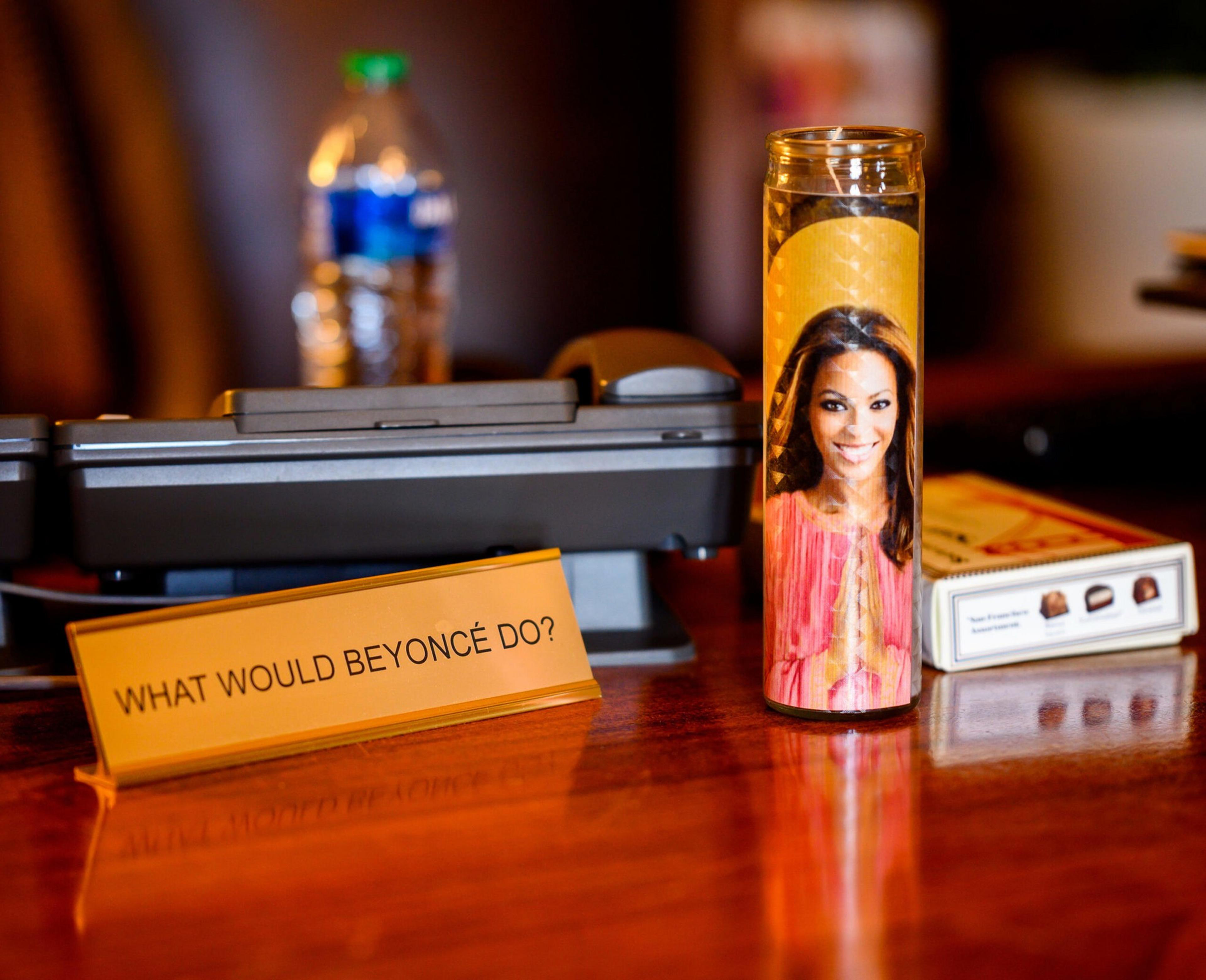 A nameplate that reads “What would Beyoncé do?” sits next to a candle of Beyoncé Knowles-Carter on Mayor London Breed's desk in San Francisco City Hall on June 1, 2023. 