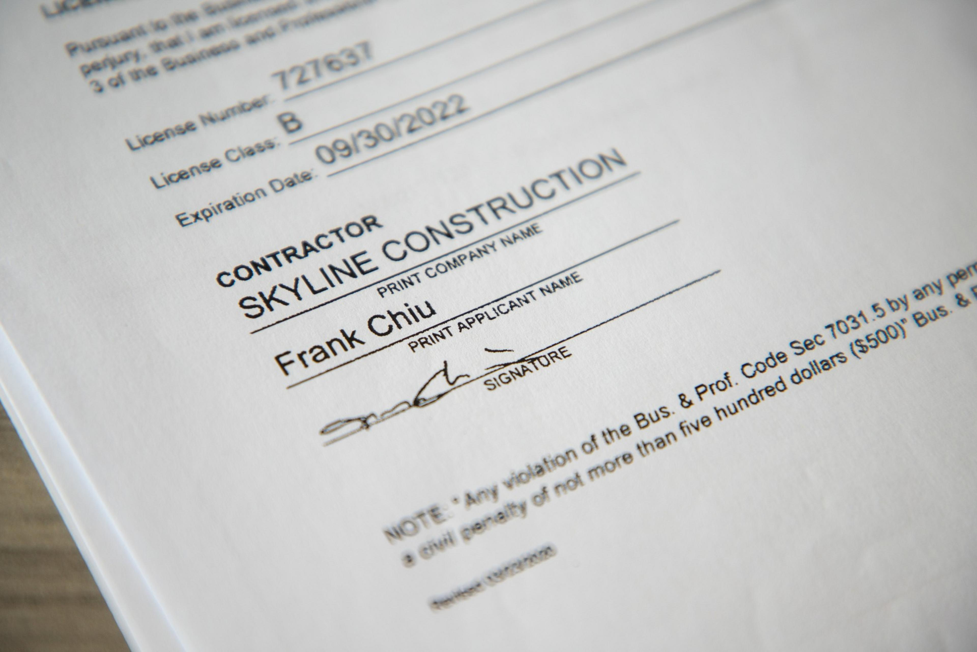A close-up of a document with a company name and a signature.