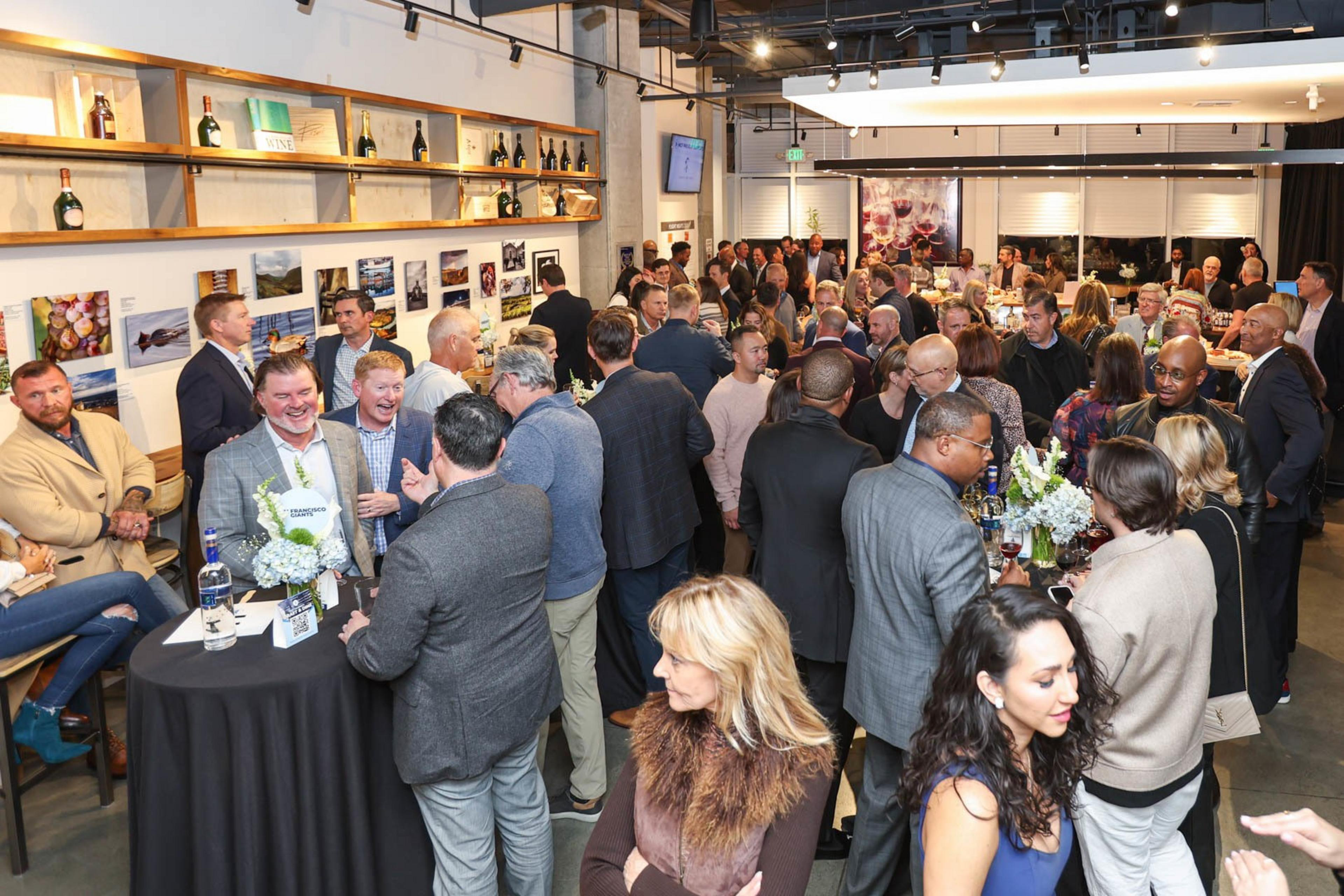 A crowd gathers in a wine bar.