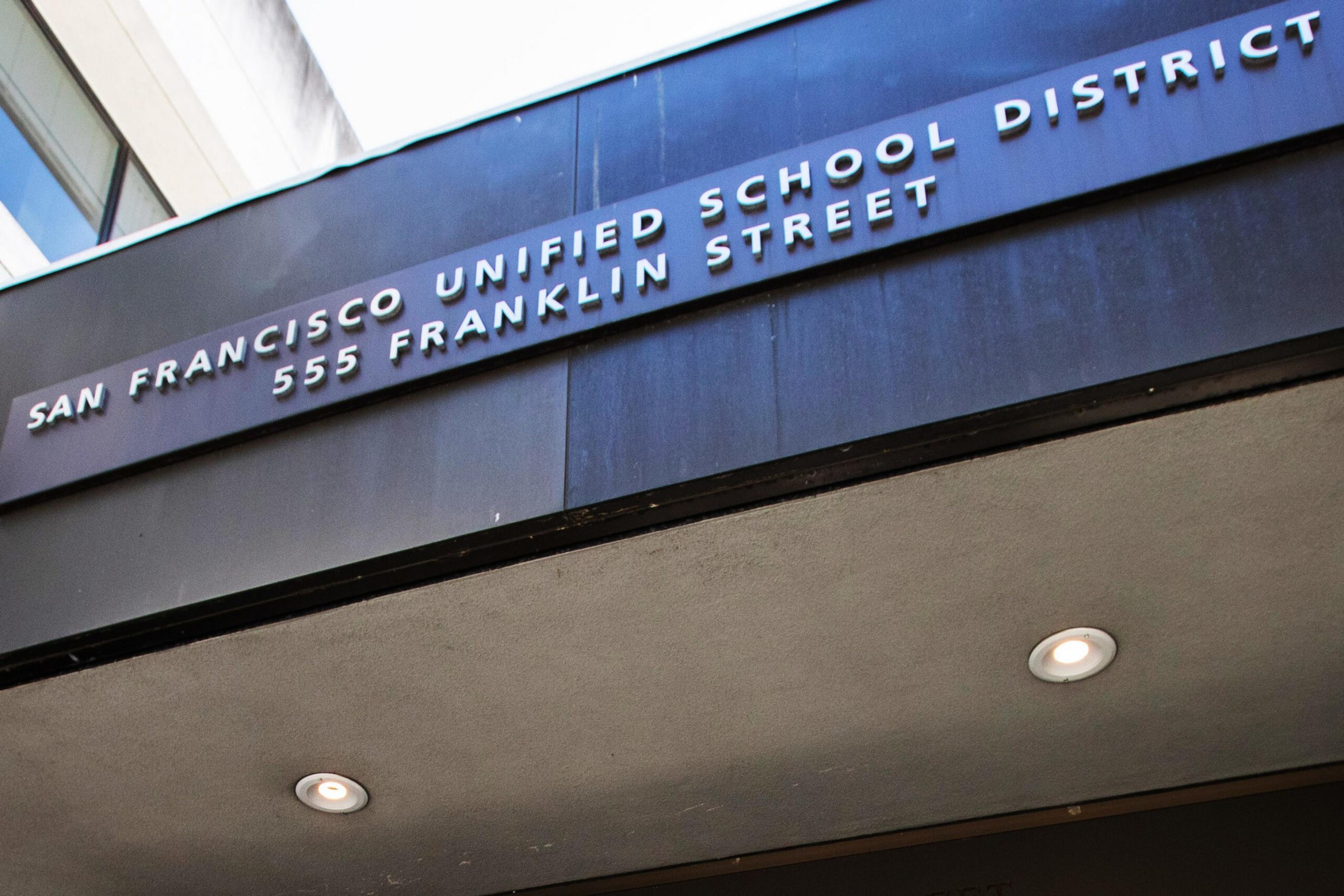 San Francisco Unified School District is displayed in raised white letters above the address 555 Franklin Street on a dark blue wall.