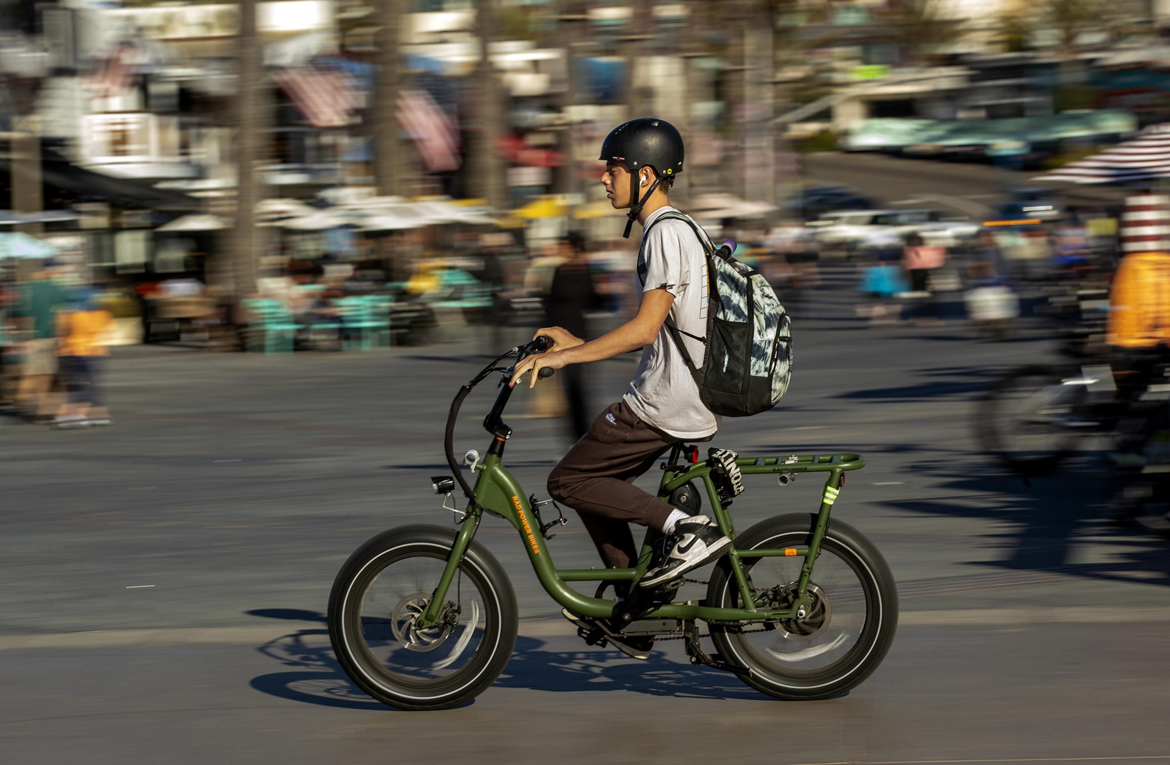 A person rides a green bike.