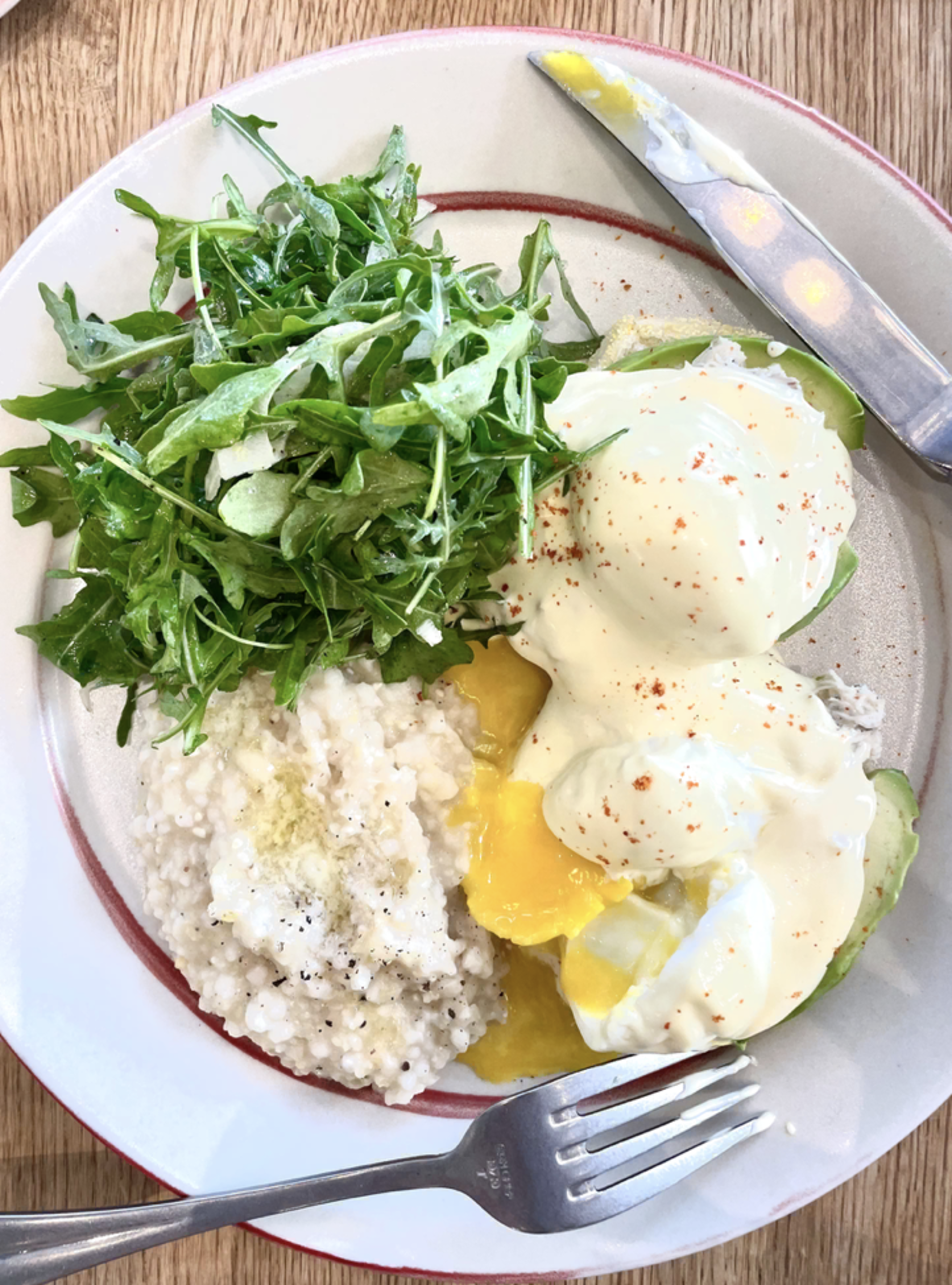 Eggs benedict with crab, grits and salad at Early to Rise