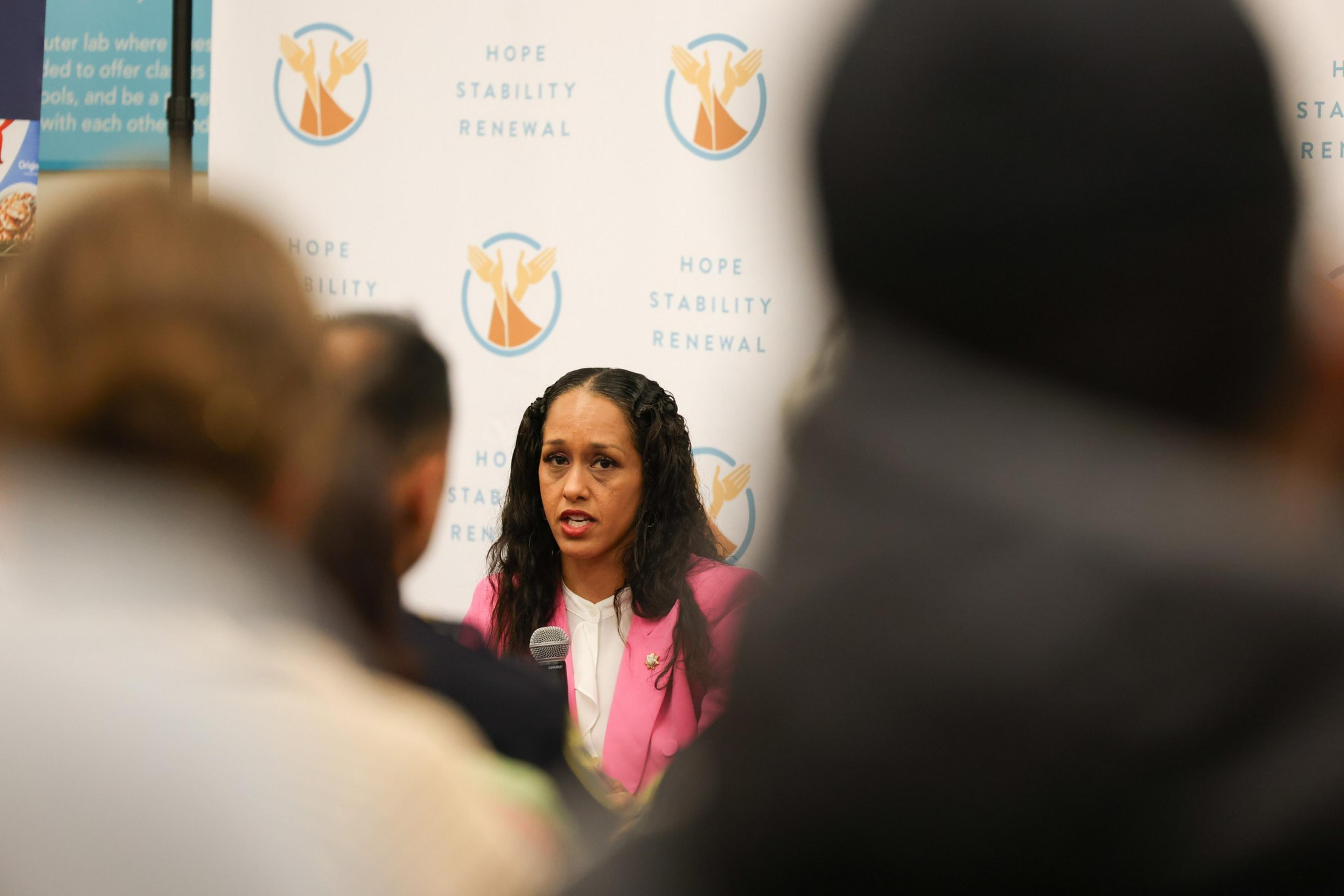 A woman speaks to a crowd.