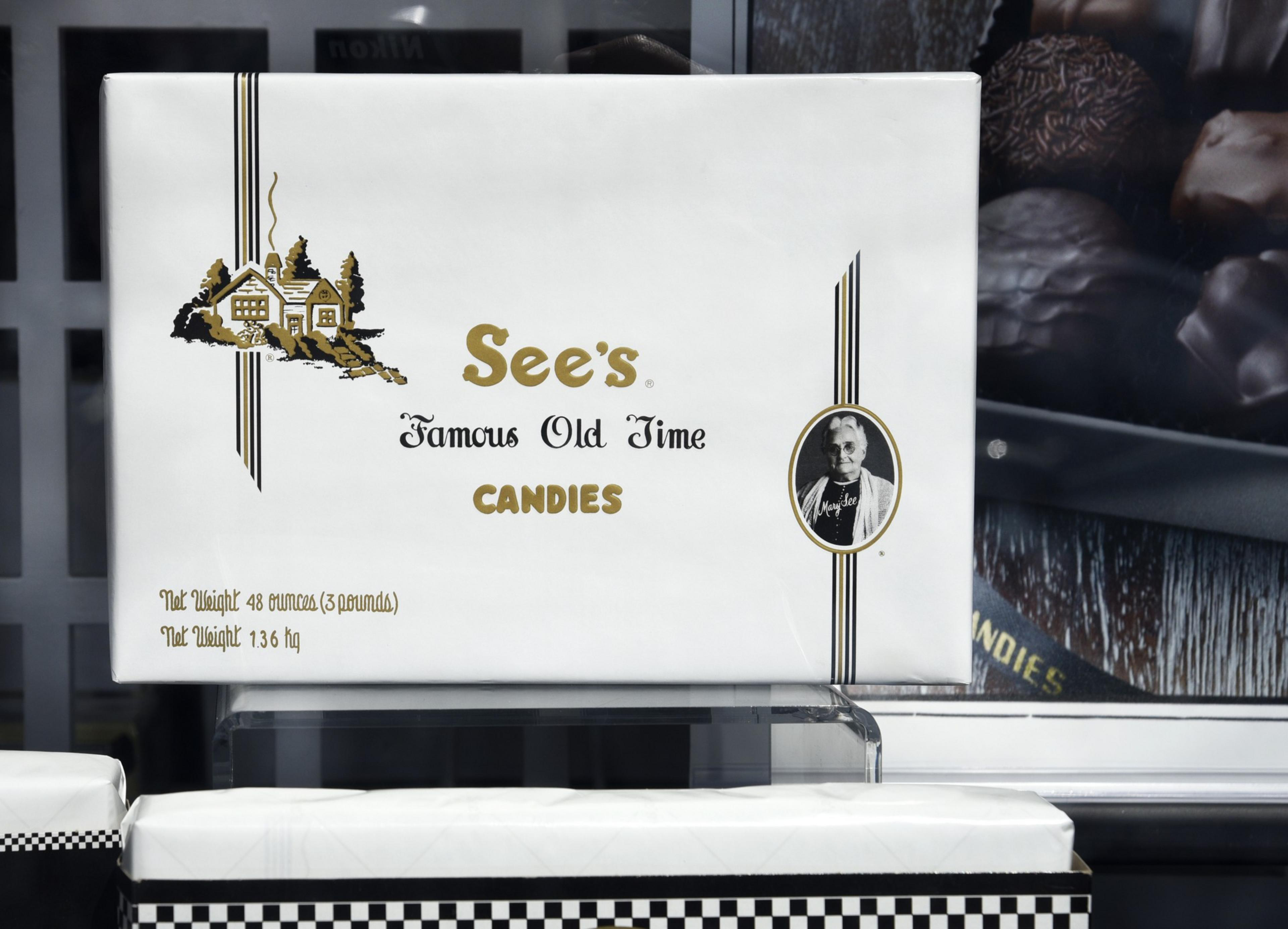 Box that says see's candies in a window