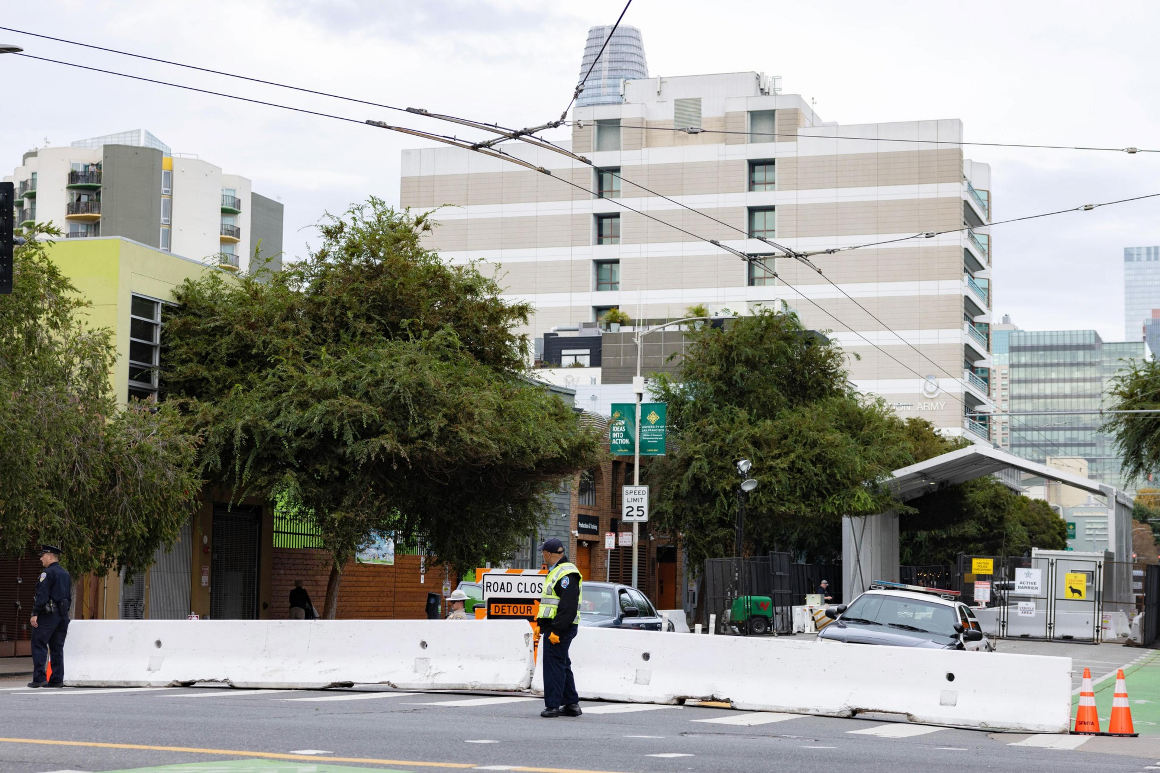 Law enforcement stand near barricades on Folsom at Fifth Street