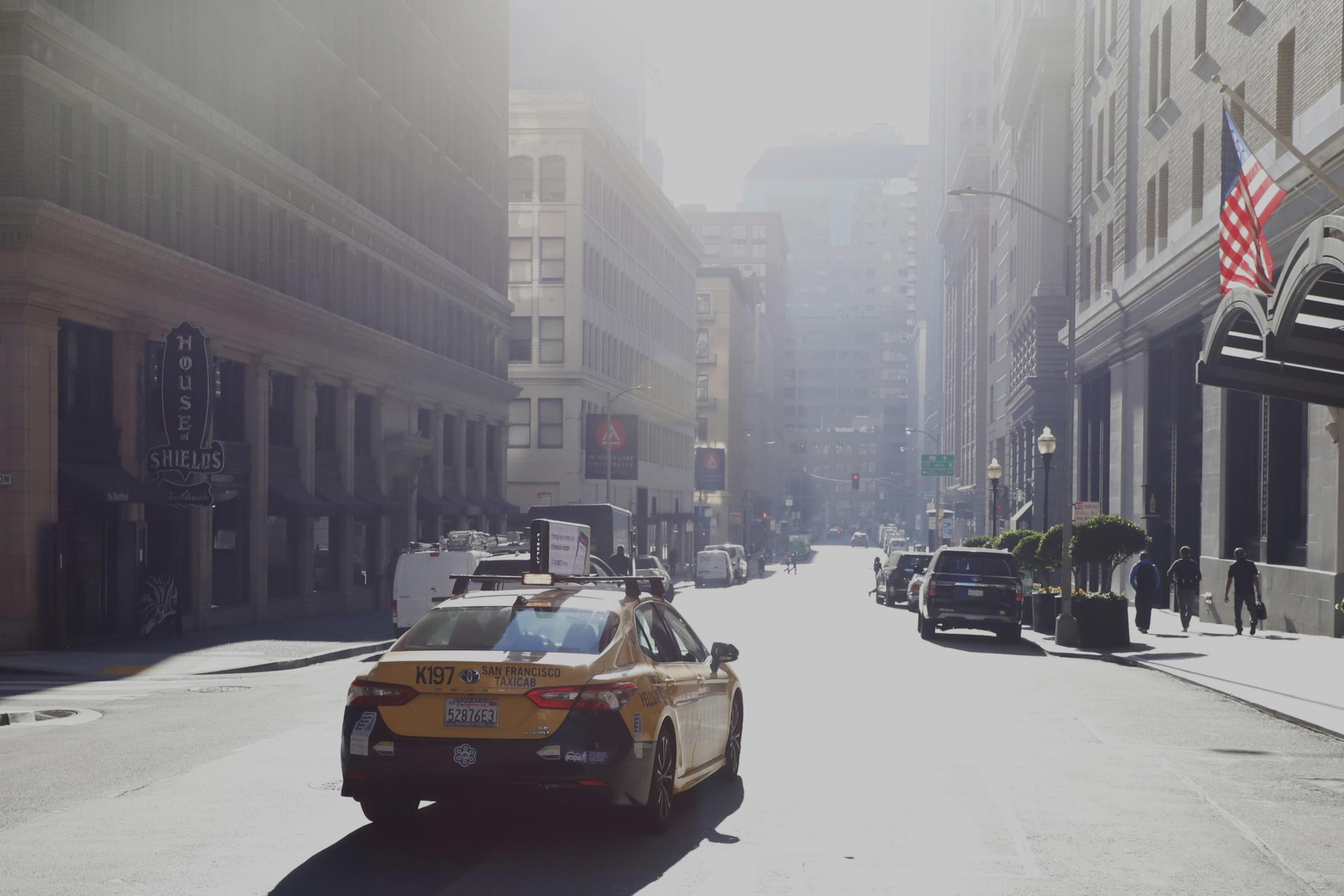 A taxi drives an empty street in San Francisco.