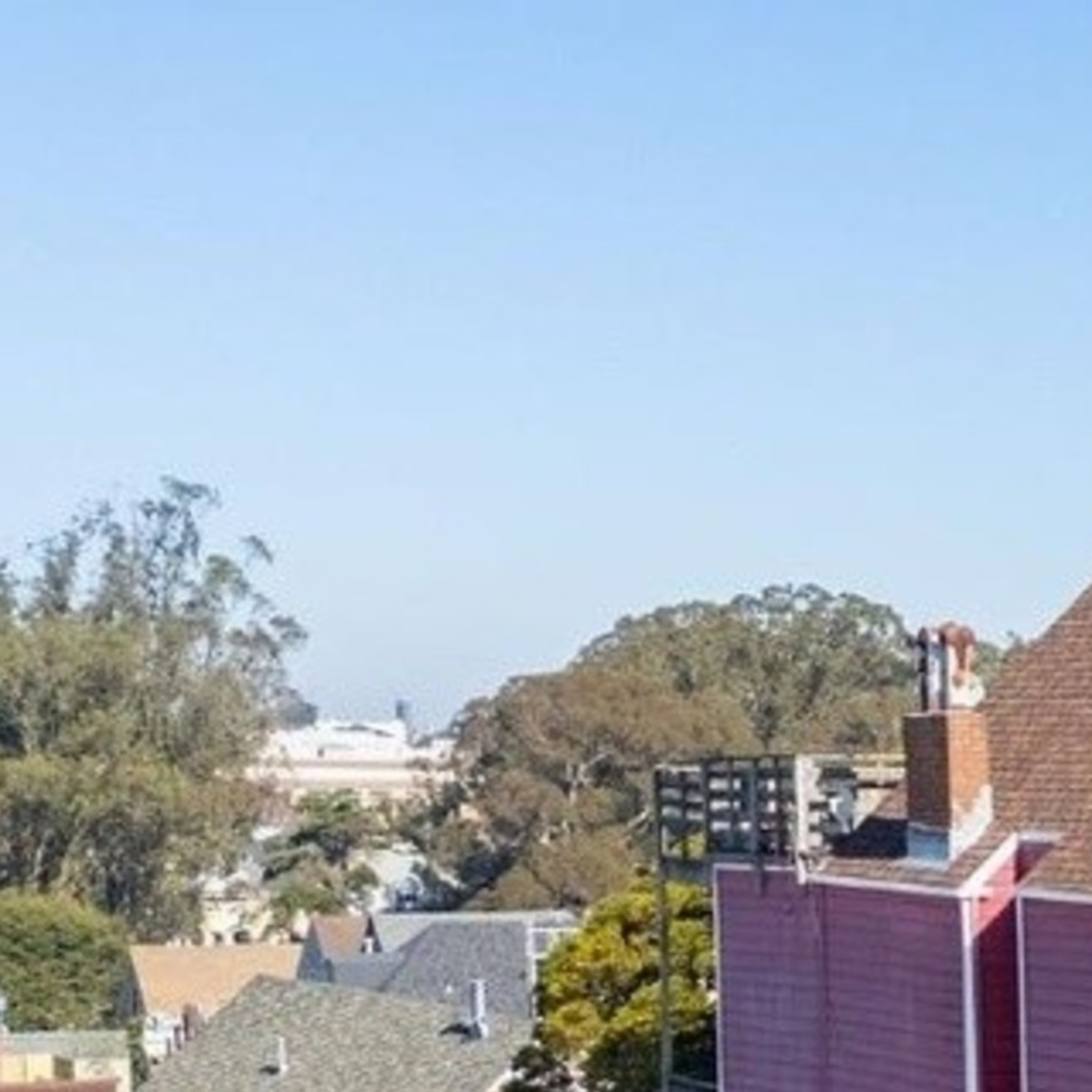 A mural of a musician holding a guitar is painted on a red building. Below, there's a colorful market with a bright striped awning and a few storefronts.