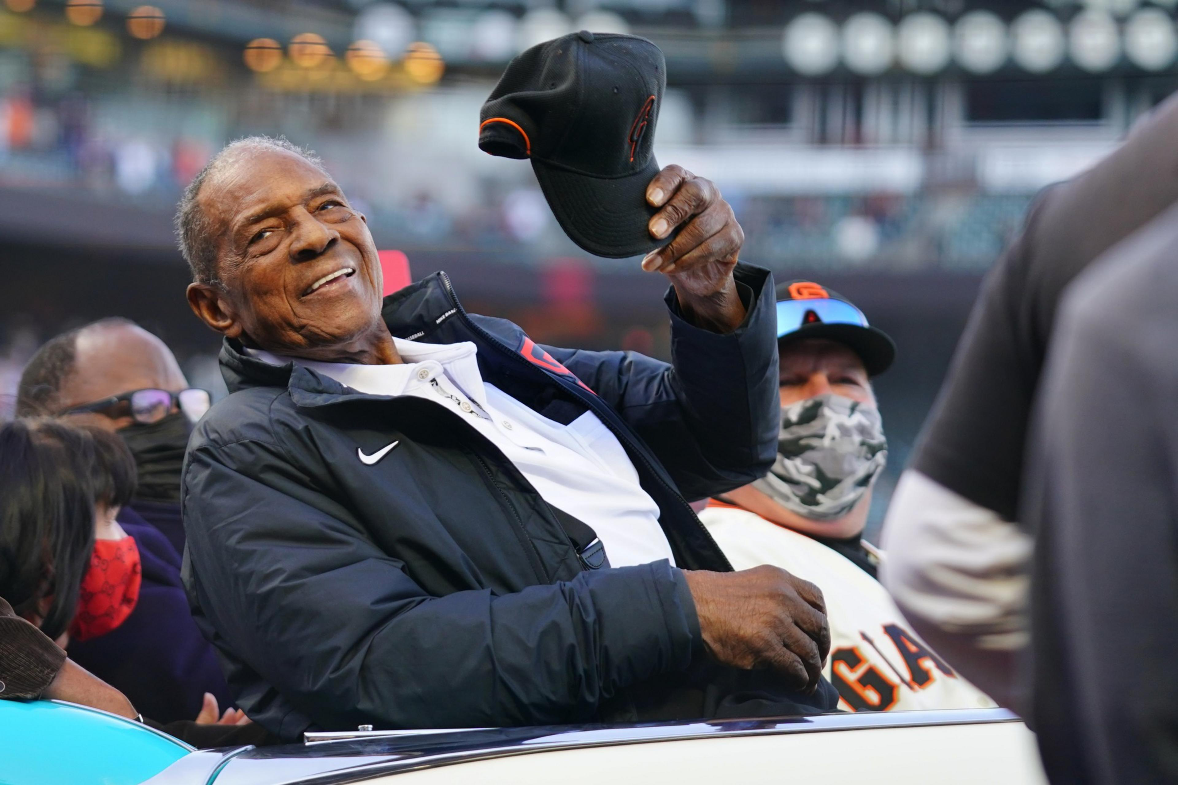 A man holds a baseball cap.