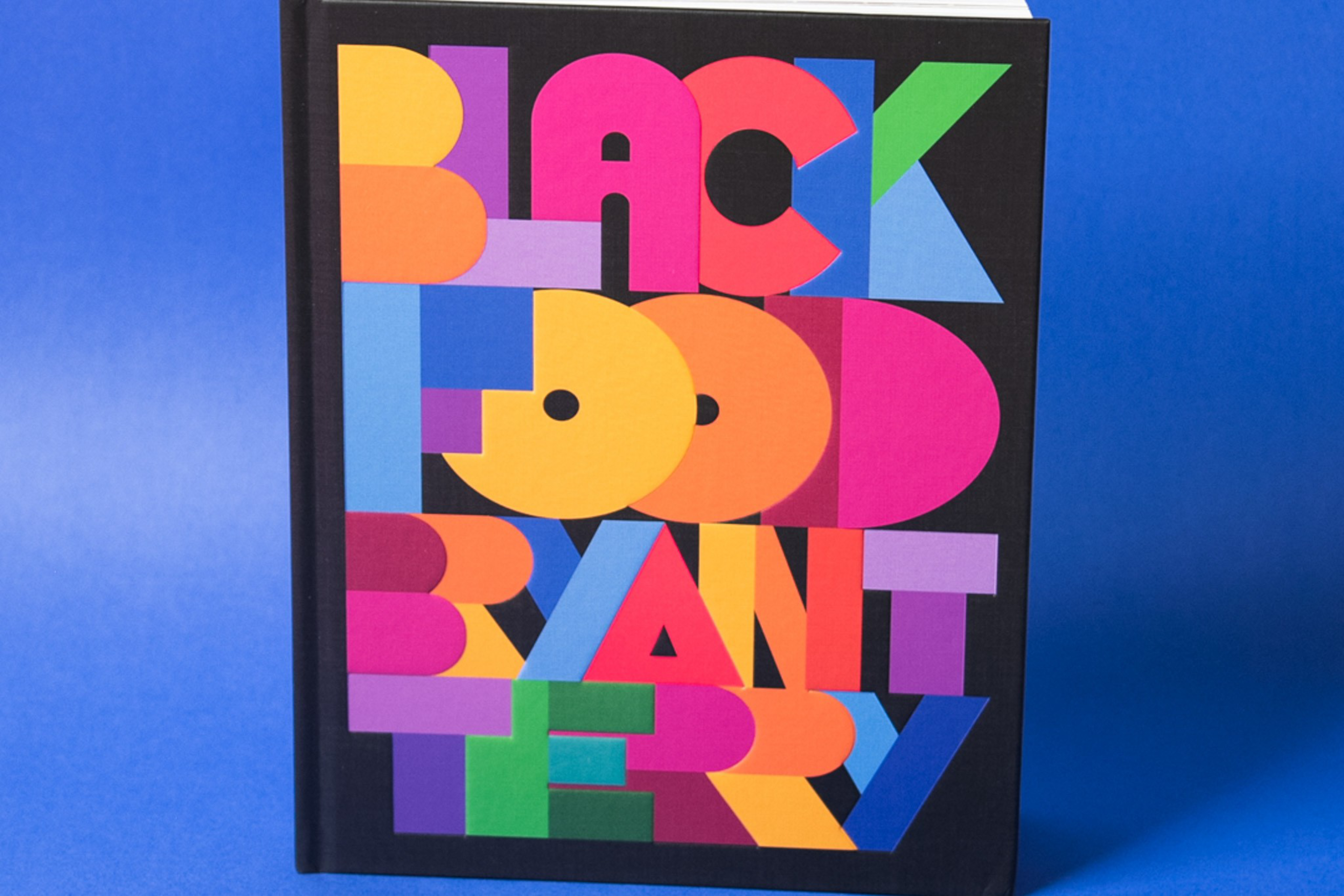 A book cover with bold, colorful block letters spells out "Black Food Brantry" against a black background.