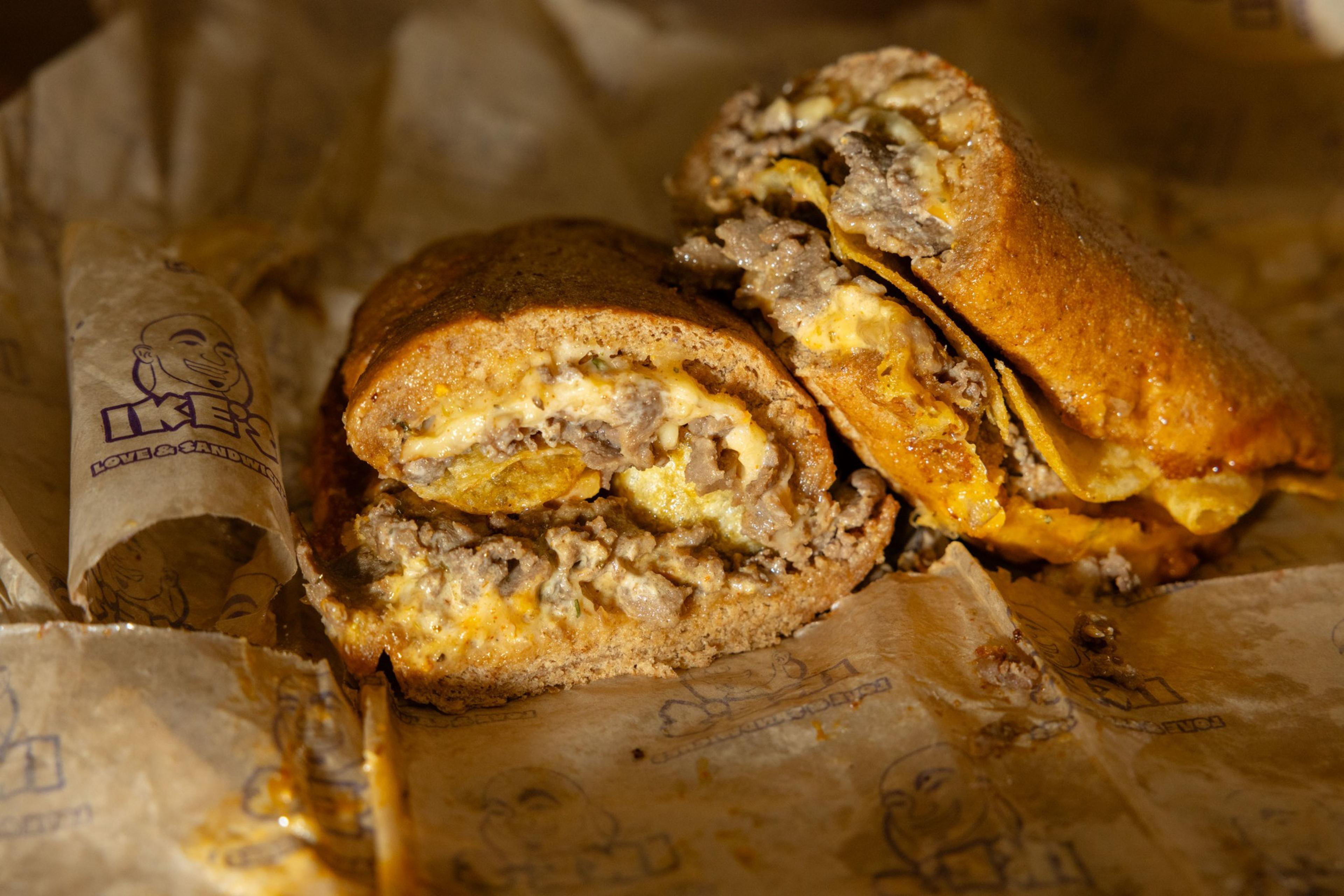 A close-up of a cheesy steak sandwich.